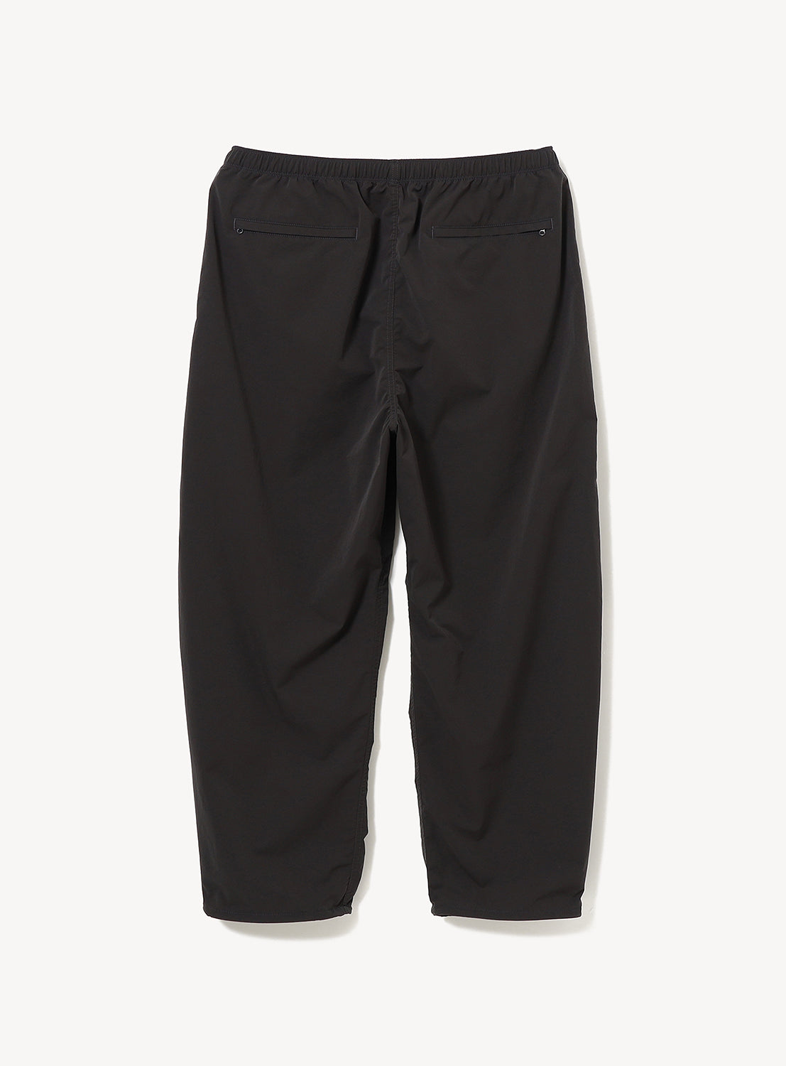 BEAMS Technical 2-Way Adjustable Easy Pants in black, featuring a wide straight fit, water-repellent fabric, an elastic waist, and two zippered back pockets.