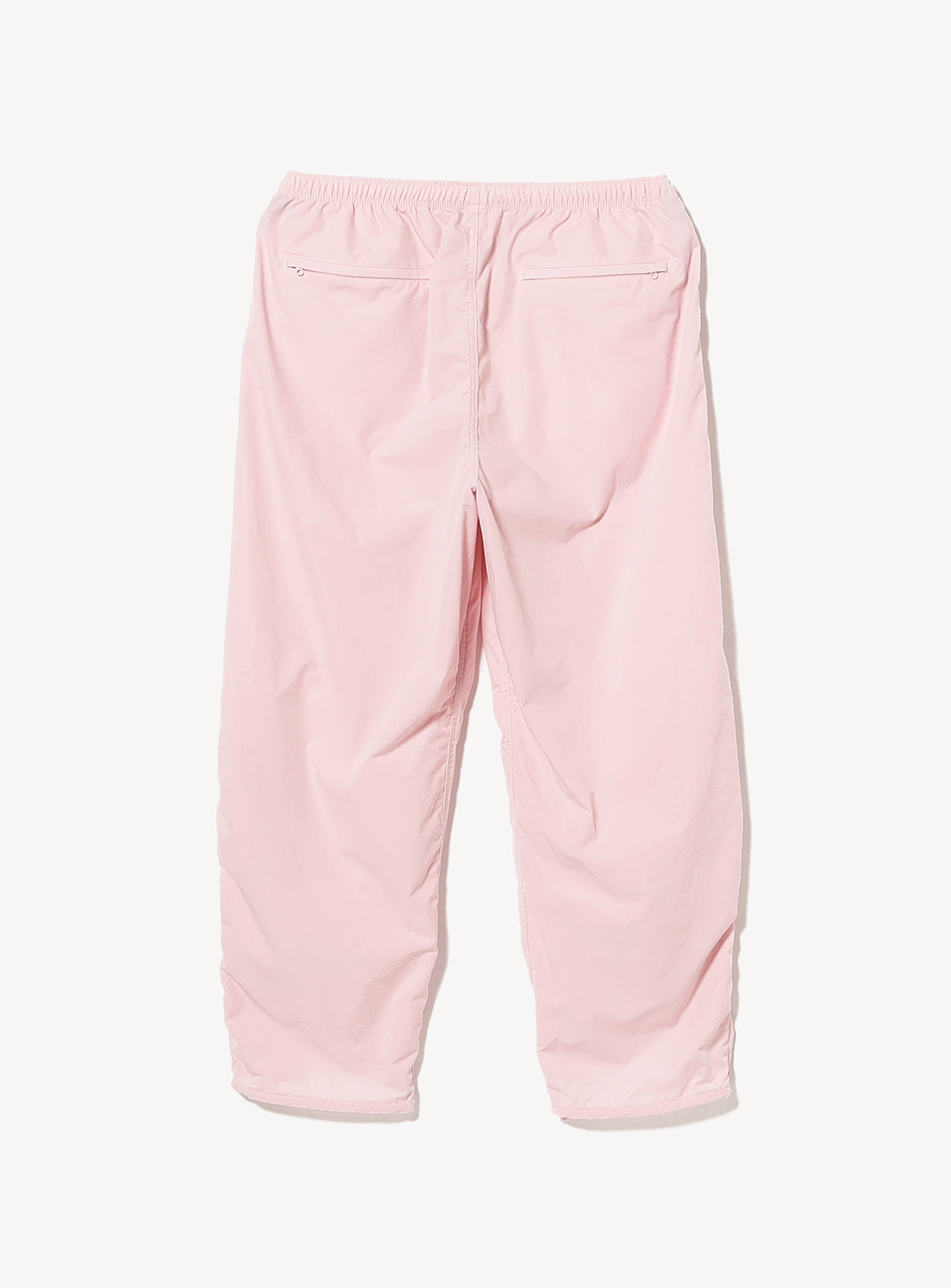 Back view of light pink BEAMS Technical 2-Way Adjustable Easy Pants featuring a wide straight leg, elastic waist, and two zippered back pockets.