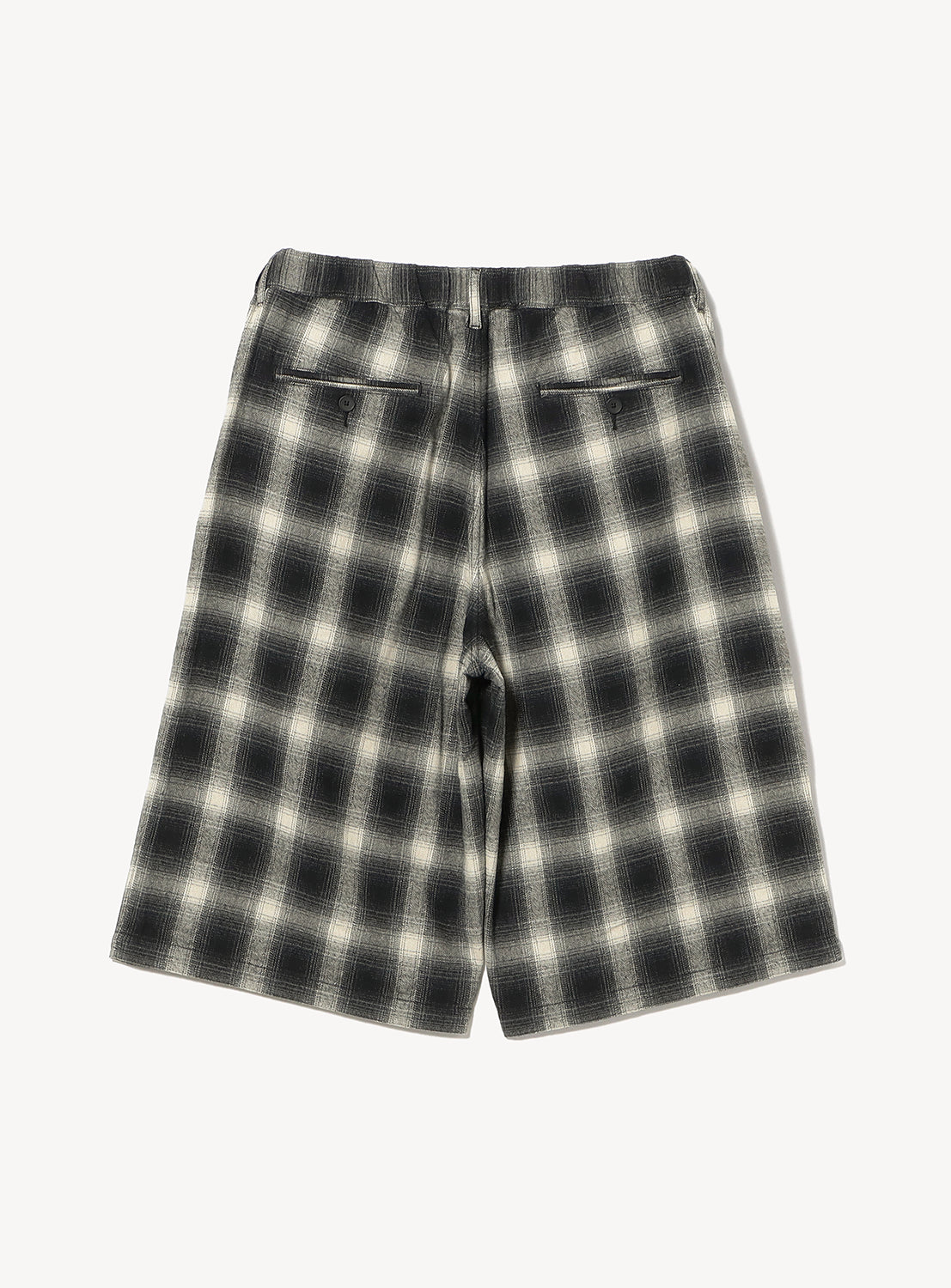 Back view of BEAMS Check Shorts, featuring a relaxed fit, black and white plaid pattern, knee-length cut, and two buttoned welt pockets.