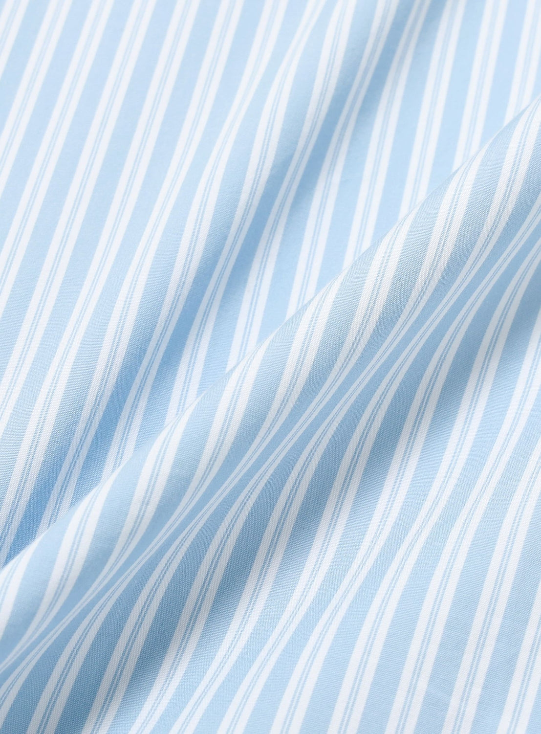 BEAMS Striped Zip-Up Shirt in light blue and white vertical pinstripe cotton fabric with soft folds.