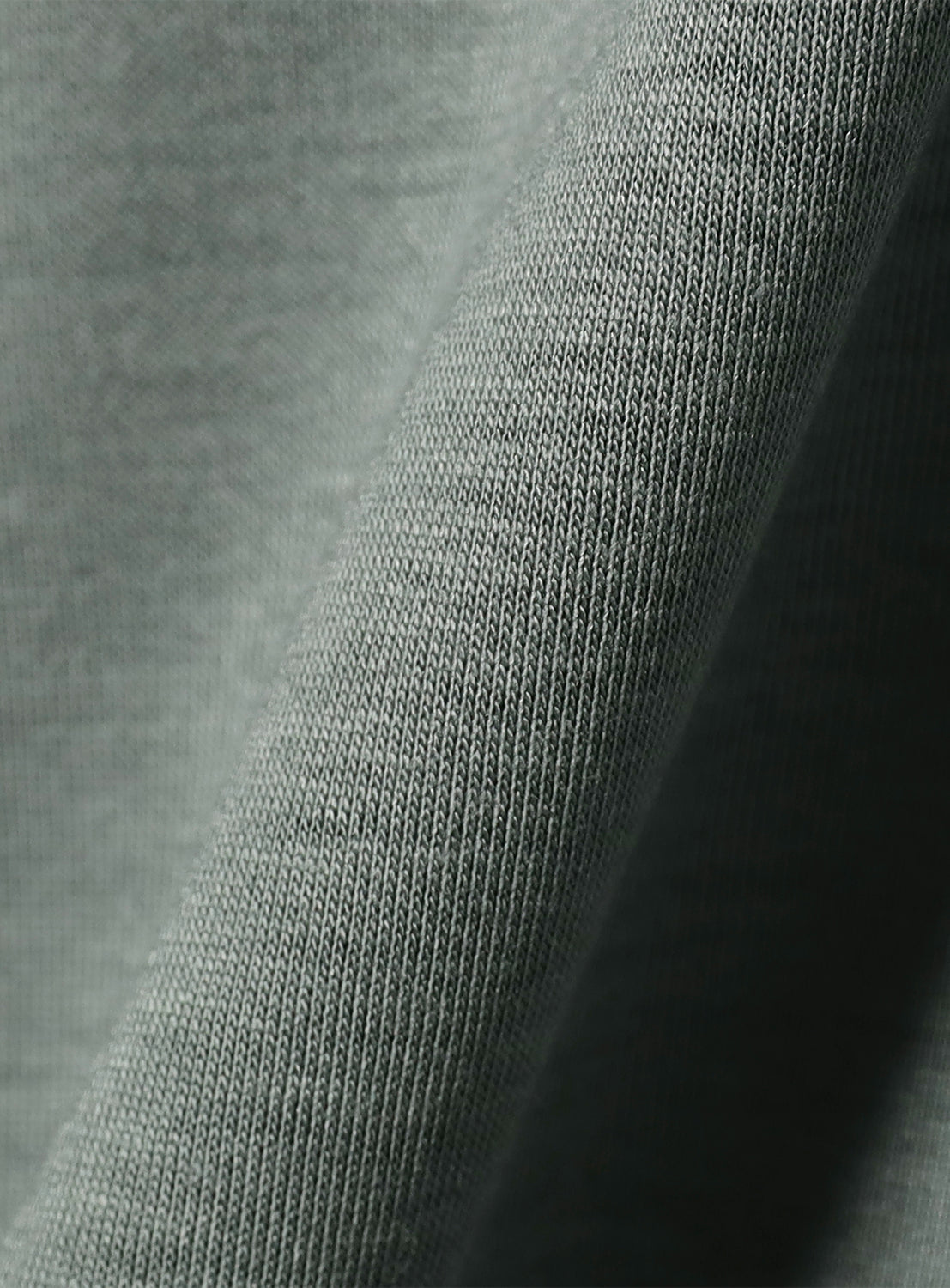 Close-up of the light green fabric, highlighting the textured weave and soft material.