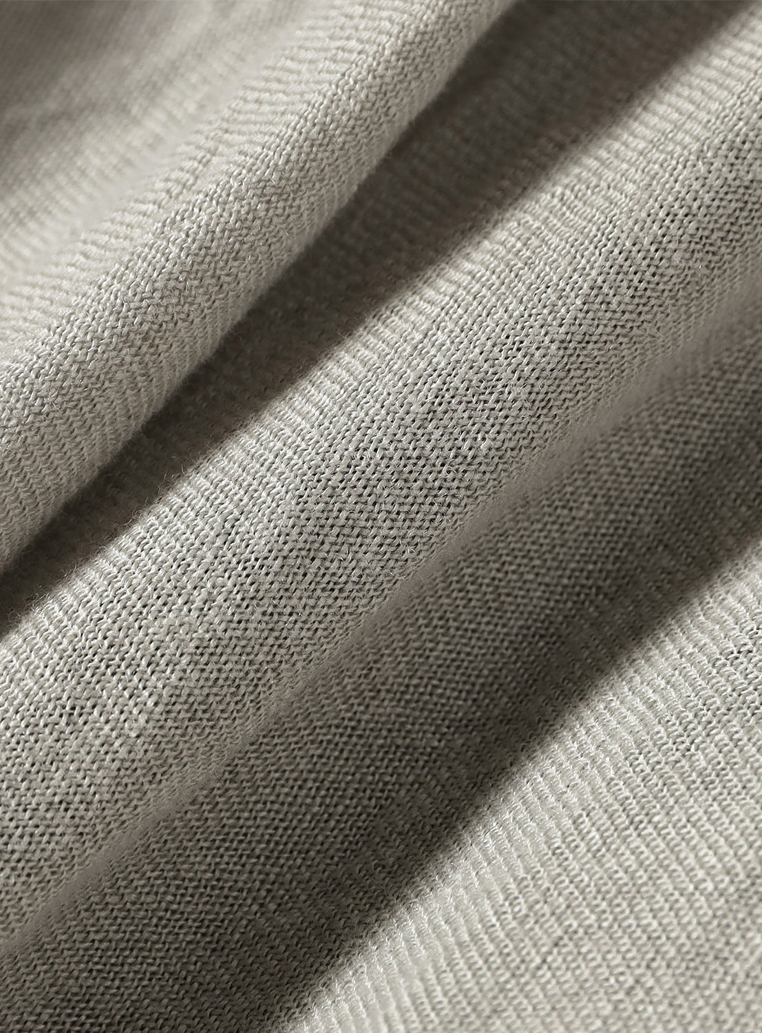 A close-up of the light grey fabric, showing a natural, slightly textured weave.