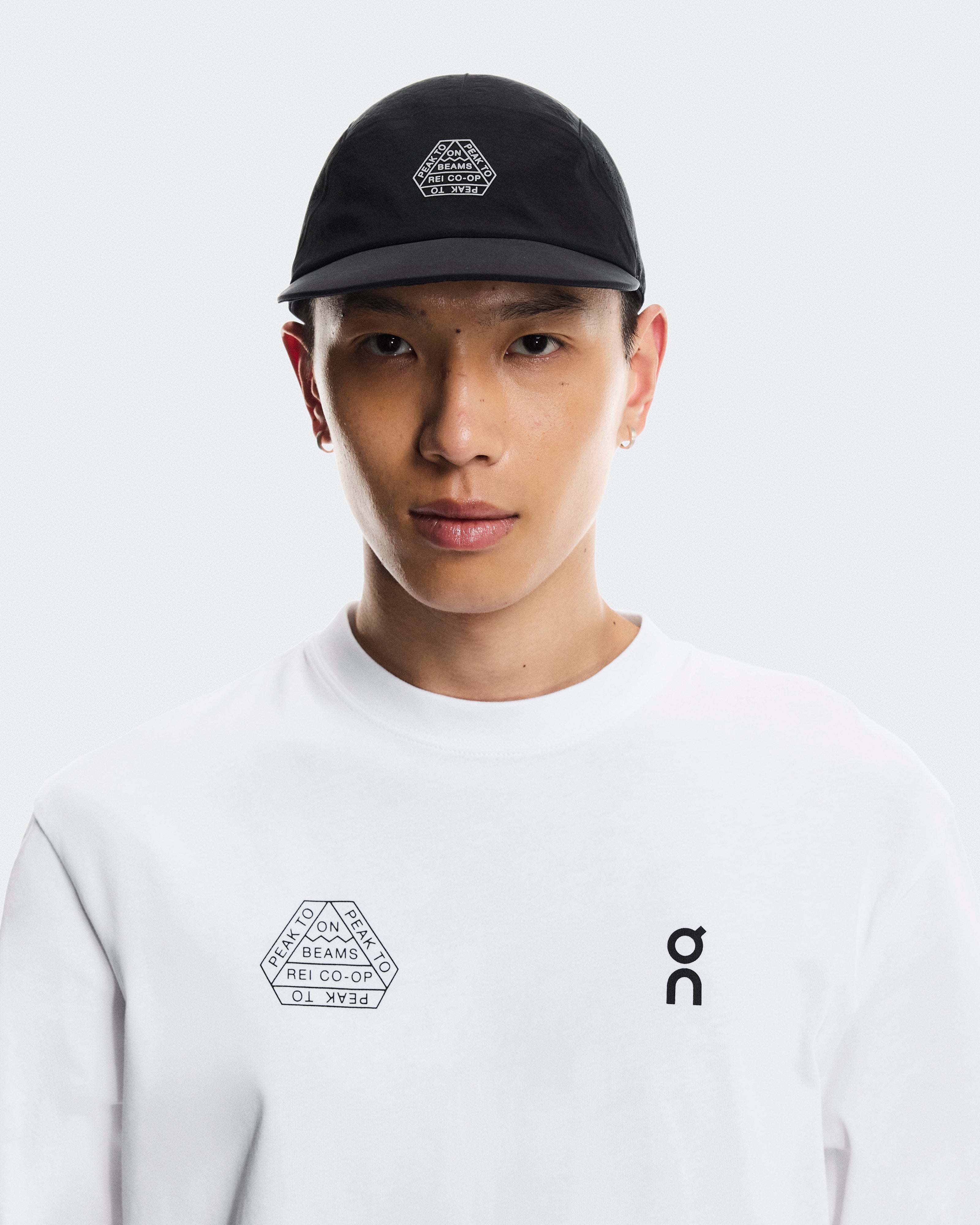 Black cap with adjustable strap and BEAMS X ON RUNNING X REI CO-OP logo.