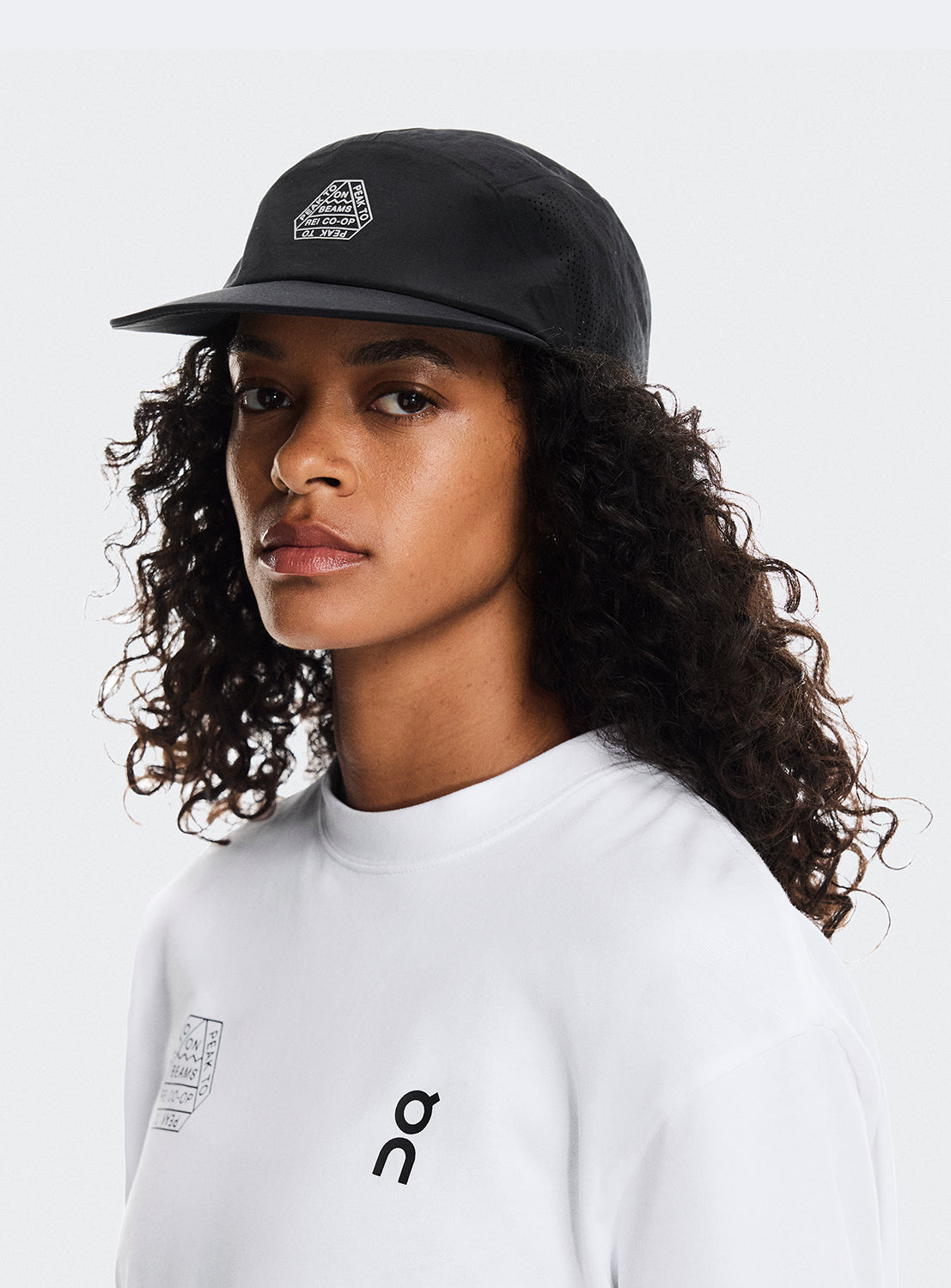 Black cap with adjustable strap and BEAMS X ON RUNNING X REI CO-OP logo.