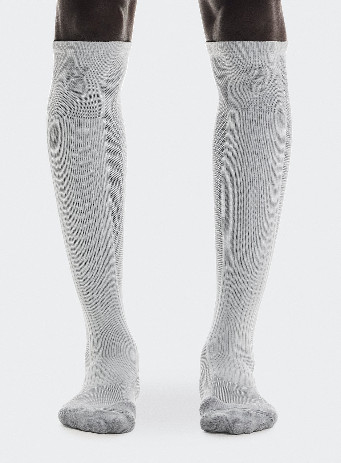 White knee-high socks with ON logo on the front. 