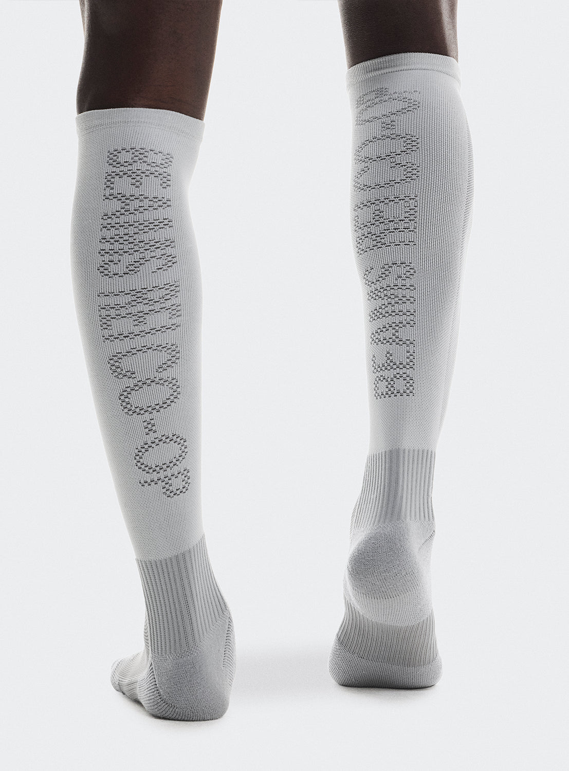 White knee-high socks with 'BEAMS REI CO-OP' text on the back. 