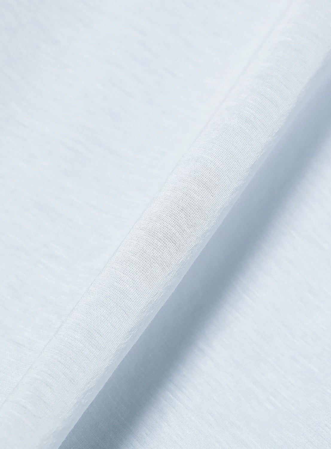 Close-up of the Ernie Palo Ringer T-shirt’s light blue, slightly textured cotton-nylon blend fabric with a visible diagonal seam. The surface looks soft and smooth.