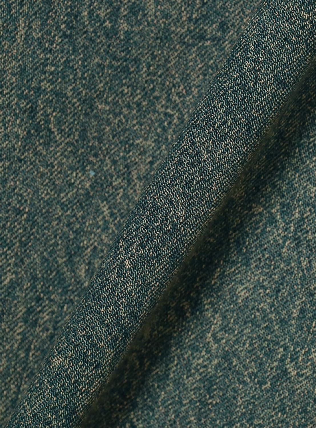 Close-up of the blue denim fabric from DAIRIKU's "Paint" Wide Denim Pants, showcasing a prominent diagonal seam that highlights the texture and weave of these vintage-inspired jeans.