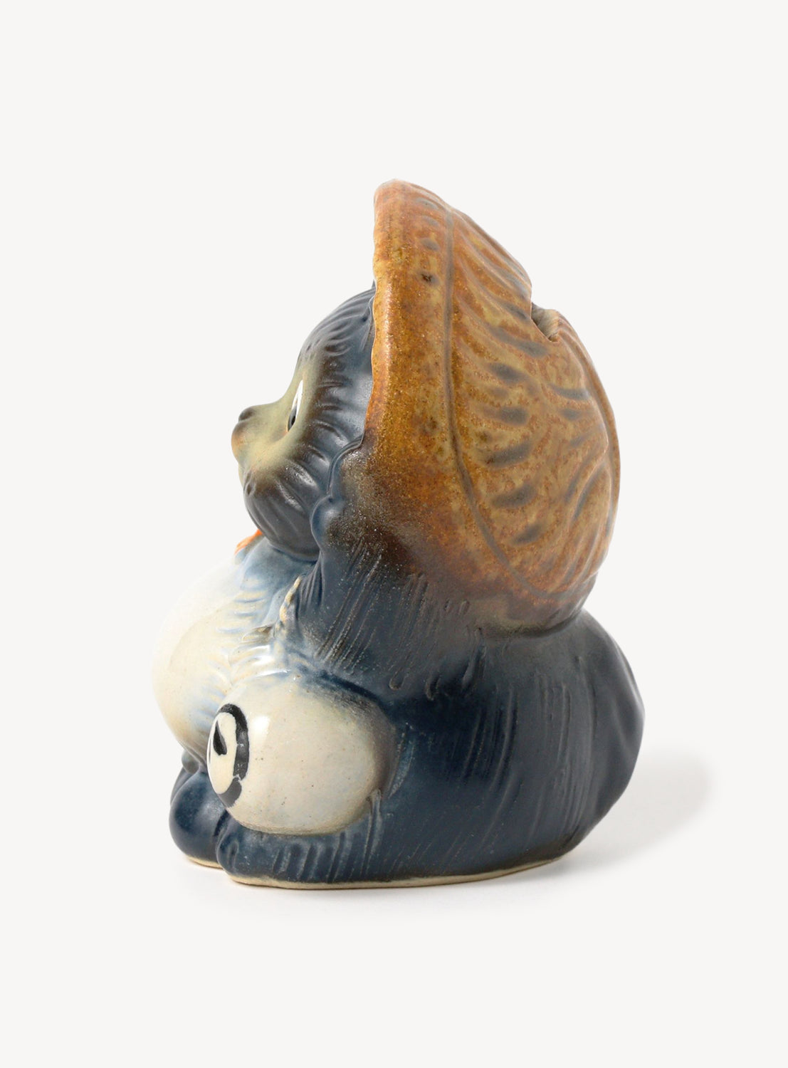 Ceramic duck figurine with a brown shell on a white background