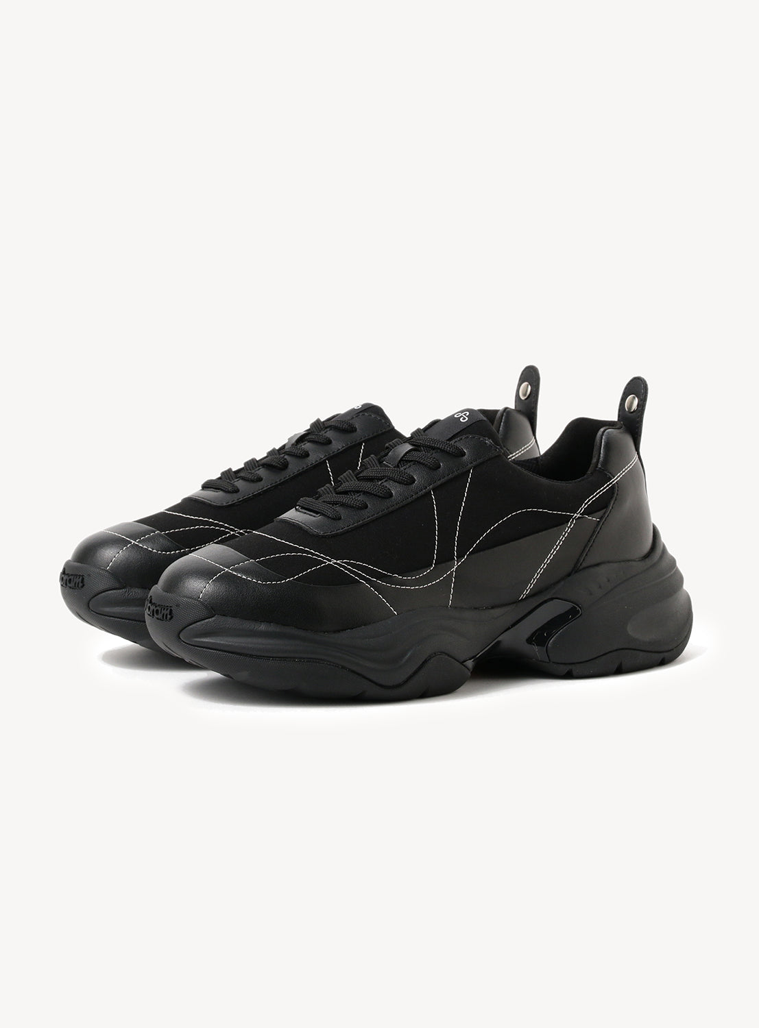 Pair of black chunky sneakers with a thick sole and white contrast stitching on a white background.