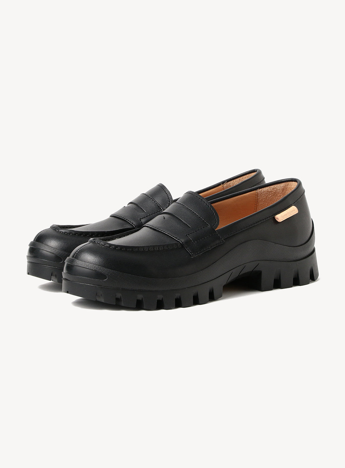 A pair of Hender Scheme Loafer #2146 by Hender Scheme, black modern loafers with chunky soles, detailed stitching, a Vibram outsole, and a small metallic label on the side, displayed against a plain white background.
