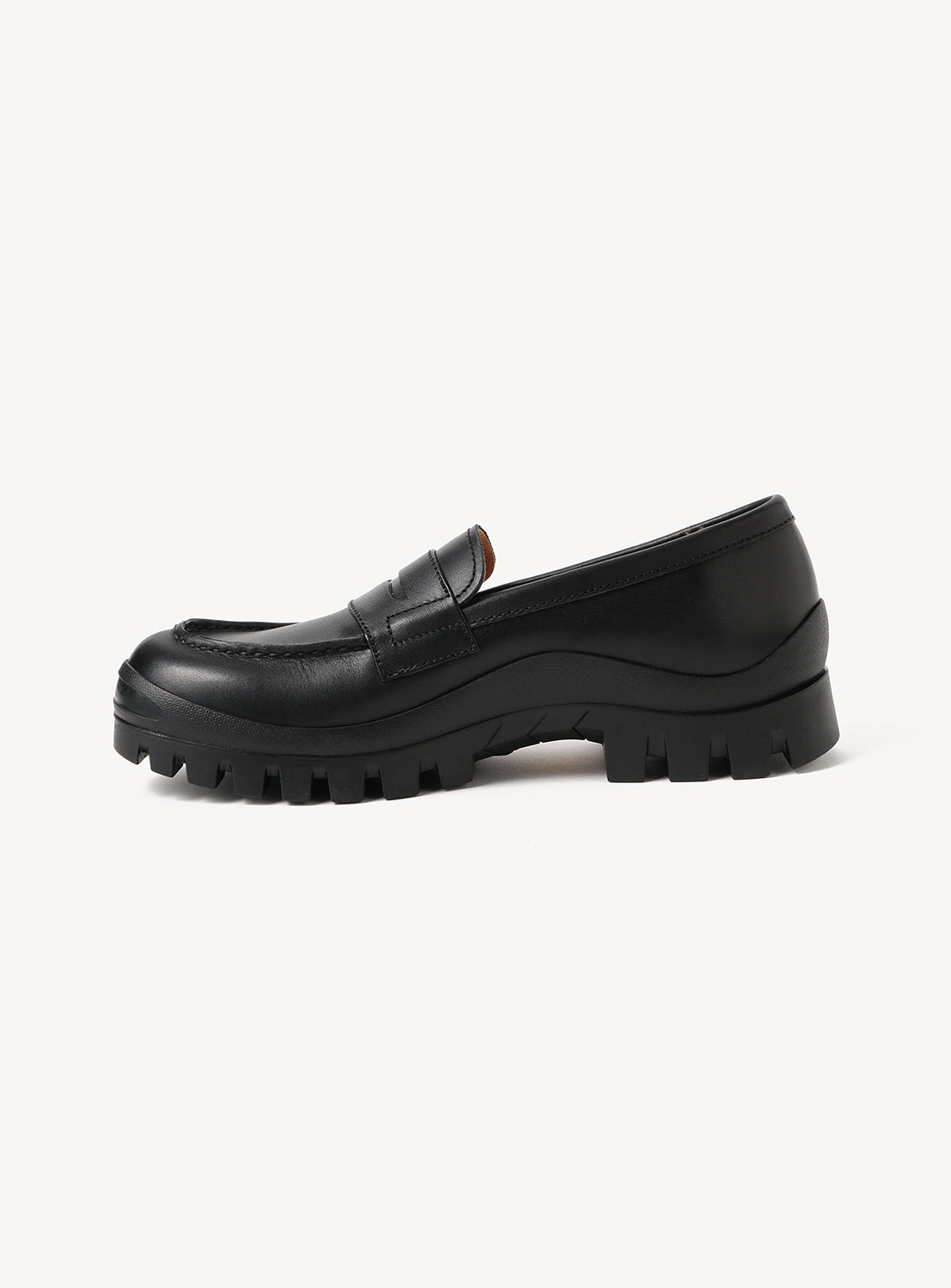 The Hender Scheme Loafer #2146 by Hender Scheme is a black leather modern loafer featuring a chunky, ridged Vibram outsole, shown from the side against a plain white background.