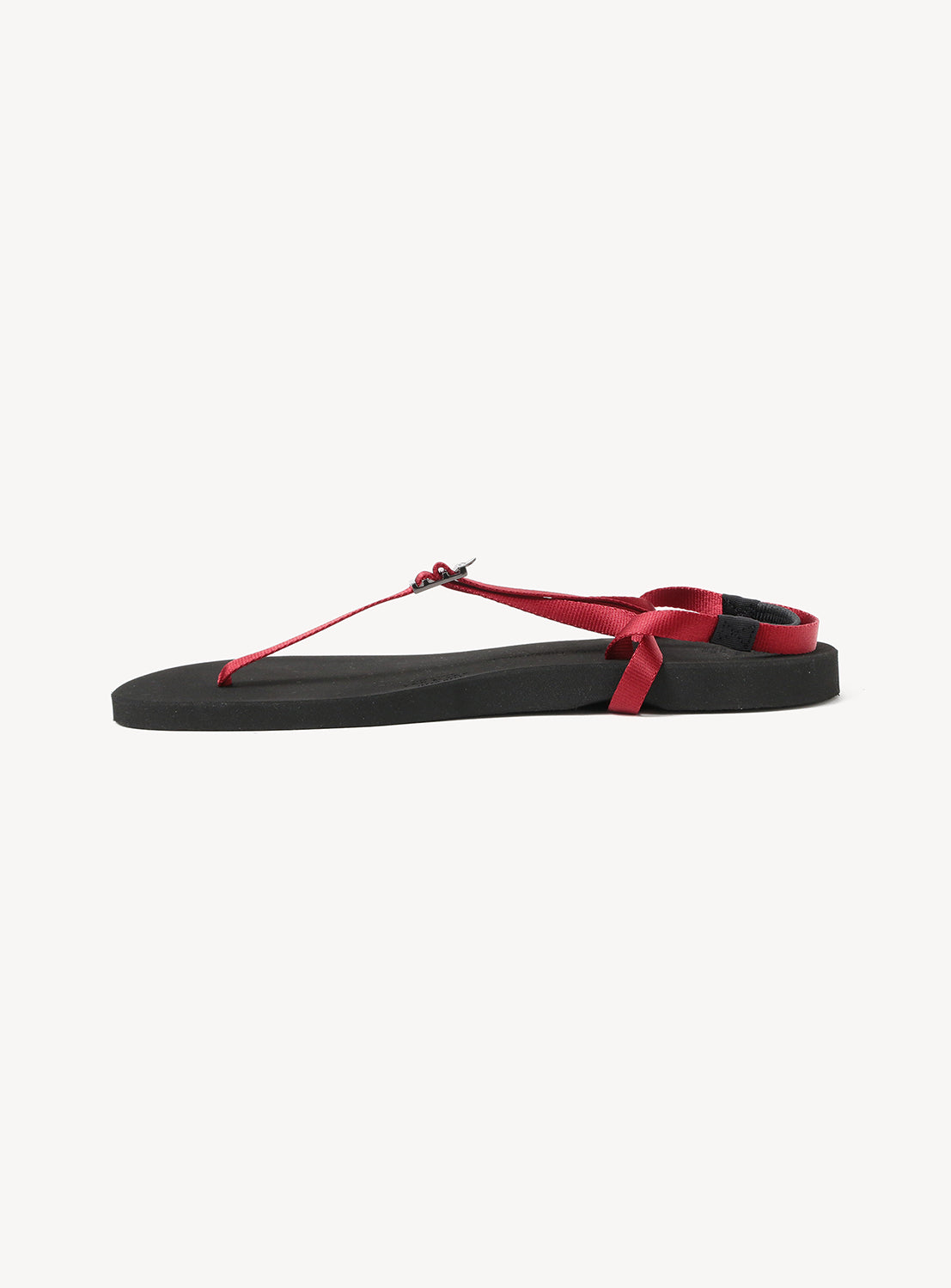 The Minimalist Huarache Barefoot Sandals by BEAUTIFUL SHOES feature a flat sole and slender red straps—including a wrap-around heel strap—presented against a simple white background, offering an elegant, refined minimalist option for barefoot sandal enthusiasts.