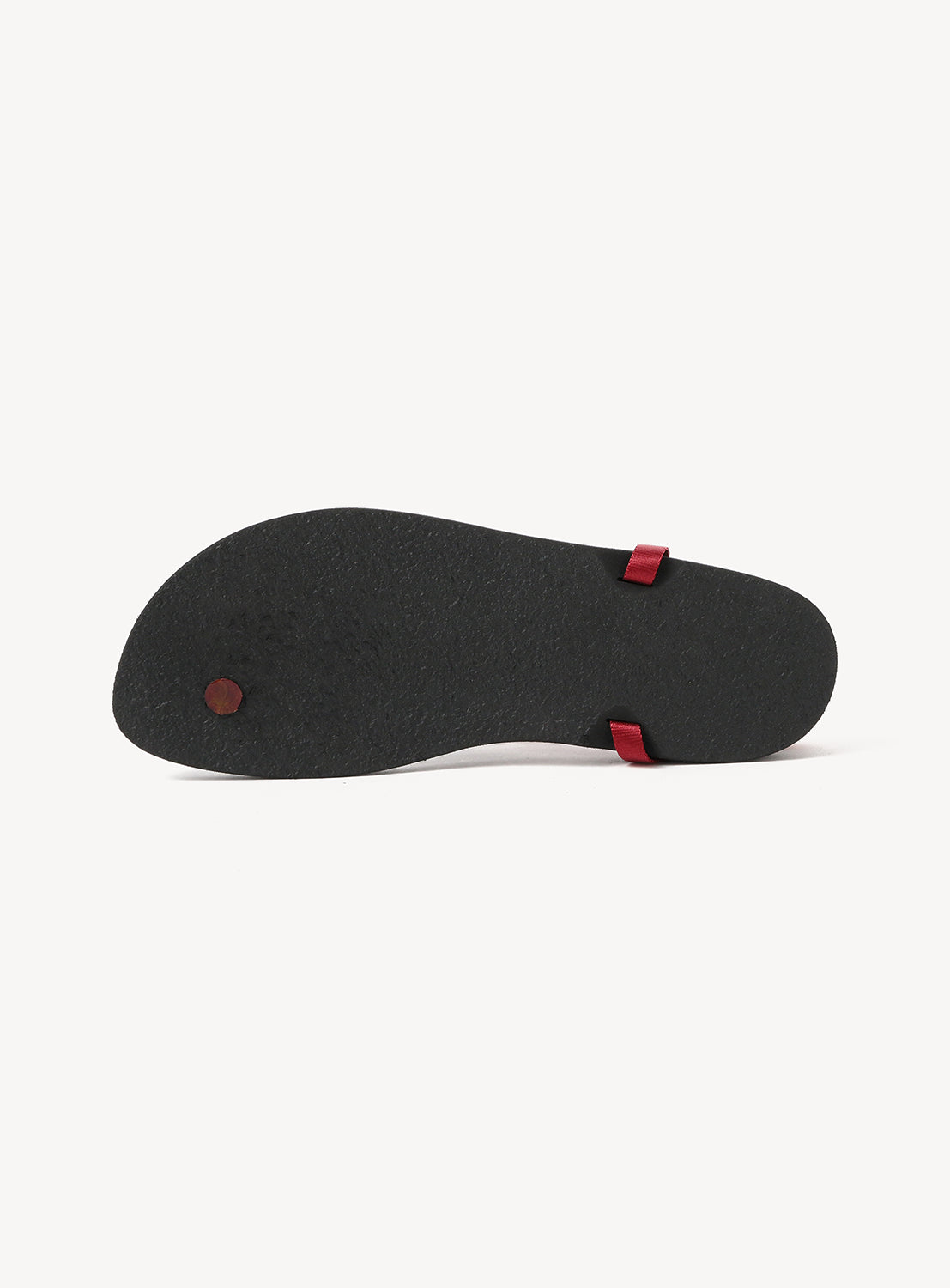 The image displays the bottom view of BEAUTIFUL SHOES' Minimalist Huarache Barefoot Sandals, featuring a black sole with two red straps against a white background, showcasing the brand's modern take on classic huarache sandal design.
