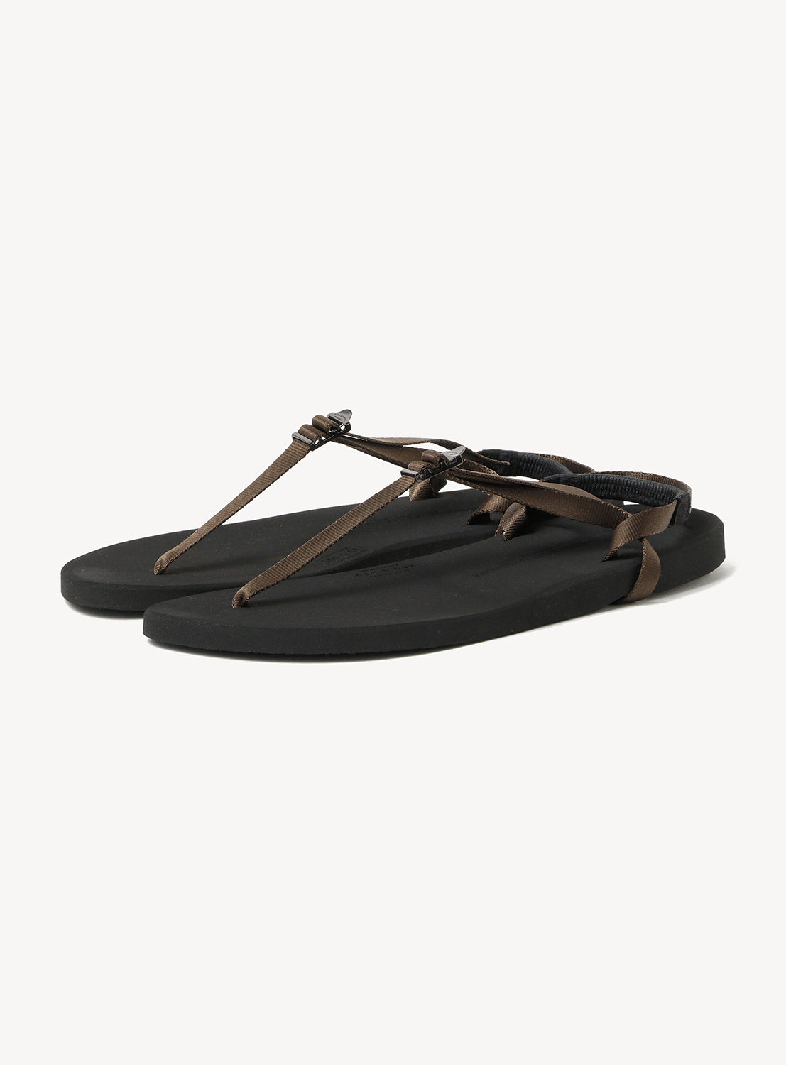 Minimalist Huarache Barefoot Sandals by BEAUTIFUL SHOES, featuring a refined minimalist silhouette with thin brown straps, a flat sole, and a sleek black design, displayed on a white background.