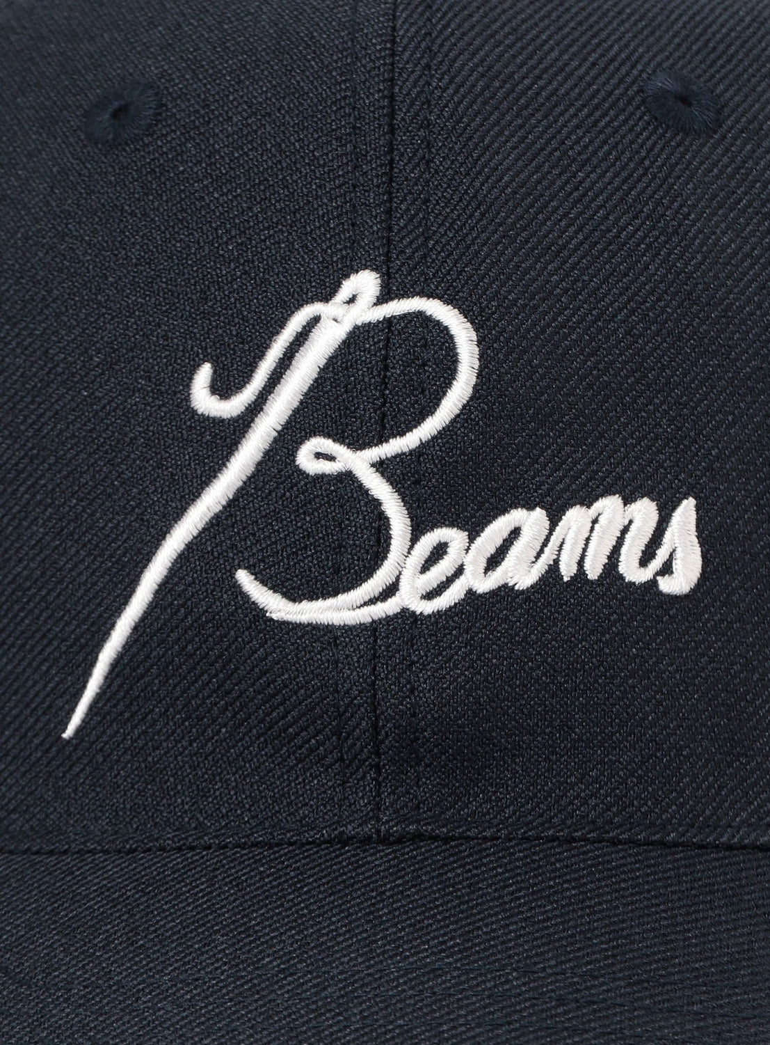 Close-up of the [Exclusive] Needles 50th Baseball Cap by NEEDLES, created as part of a special collaboration, featuring the word “Beams” elegantly embroidered in white script across the front.