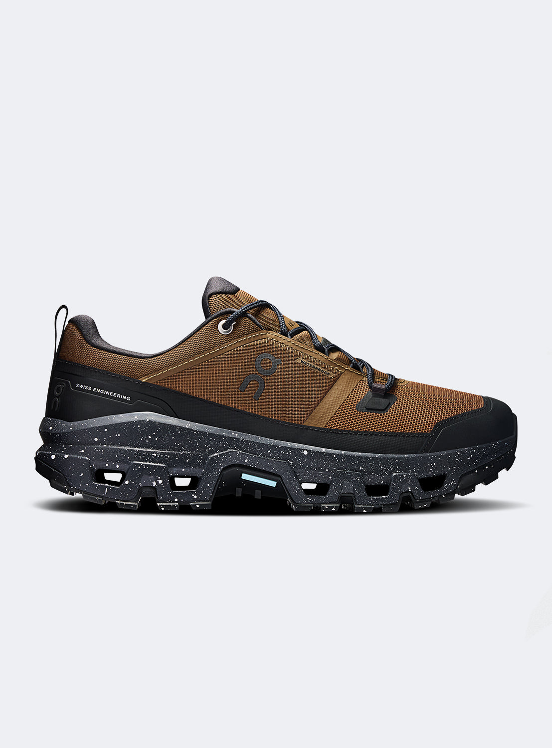 Side view of brown and black hiking shoes with a black speckled sole. 