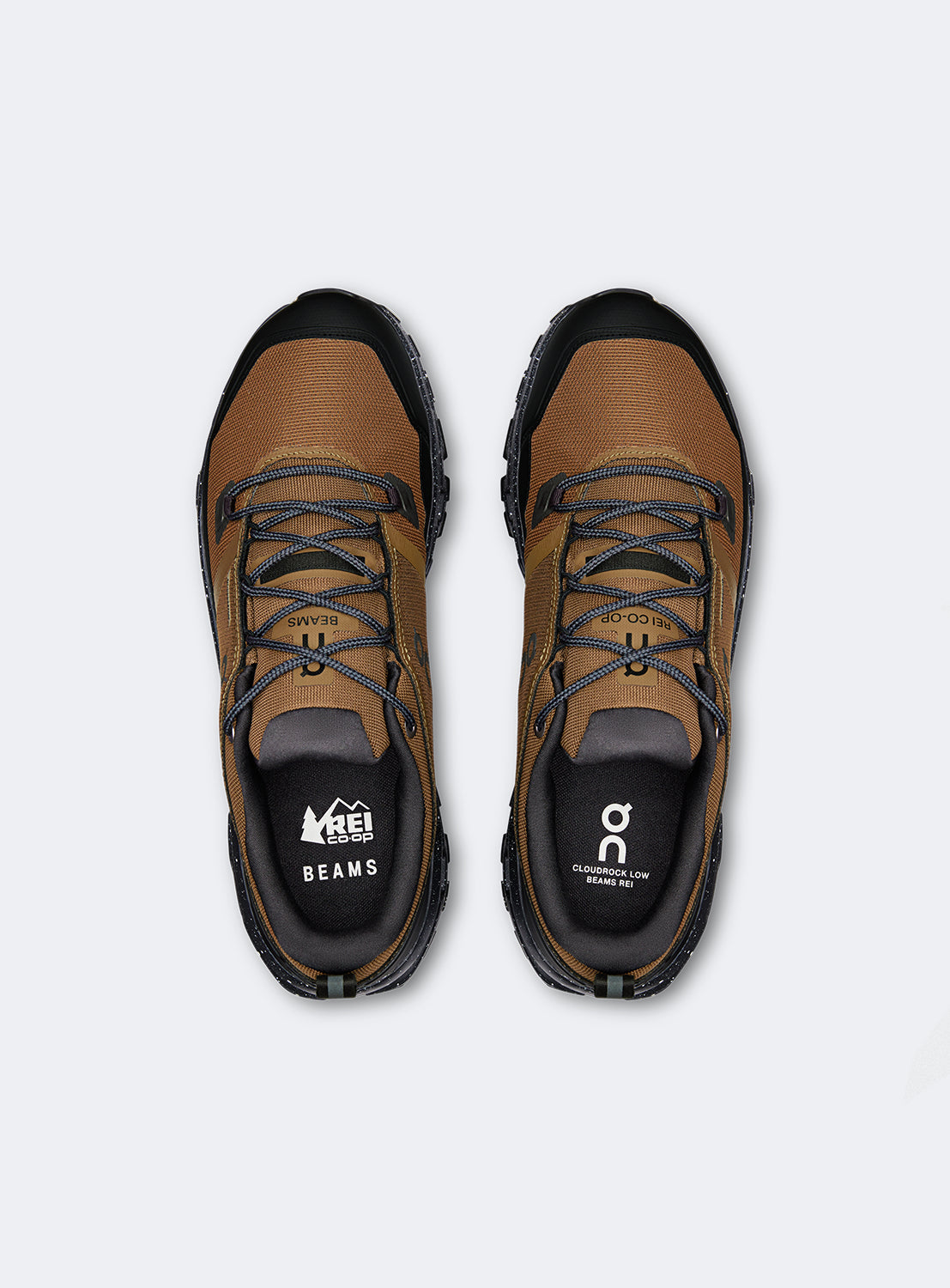 Birdseye view of a brown and black hiking shoes with a black speckled sole. 