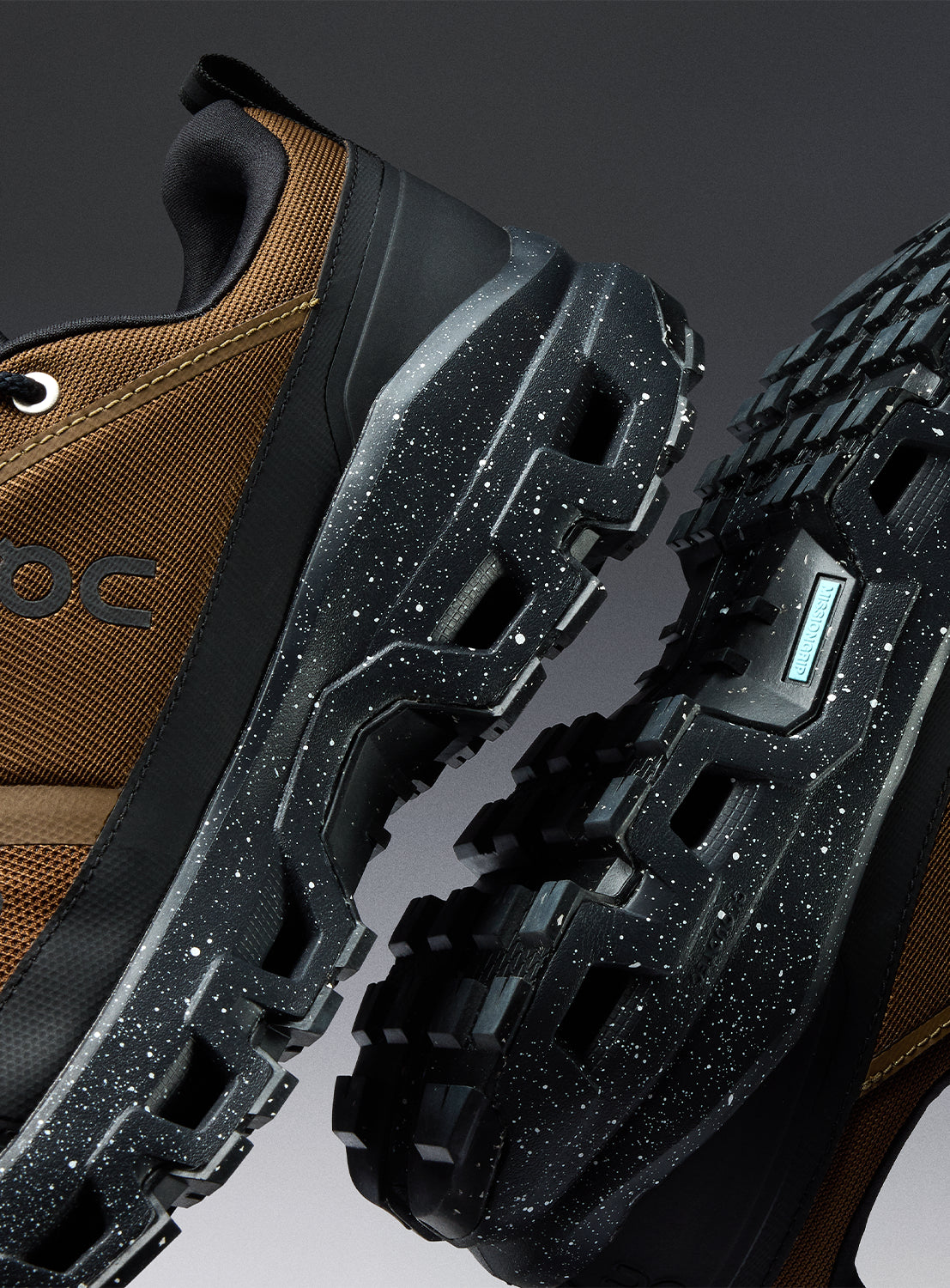 Close-up of a brown hiking shoe with black speckled sole. 