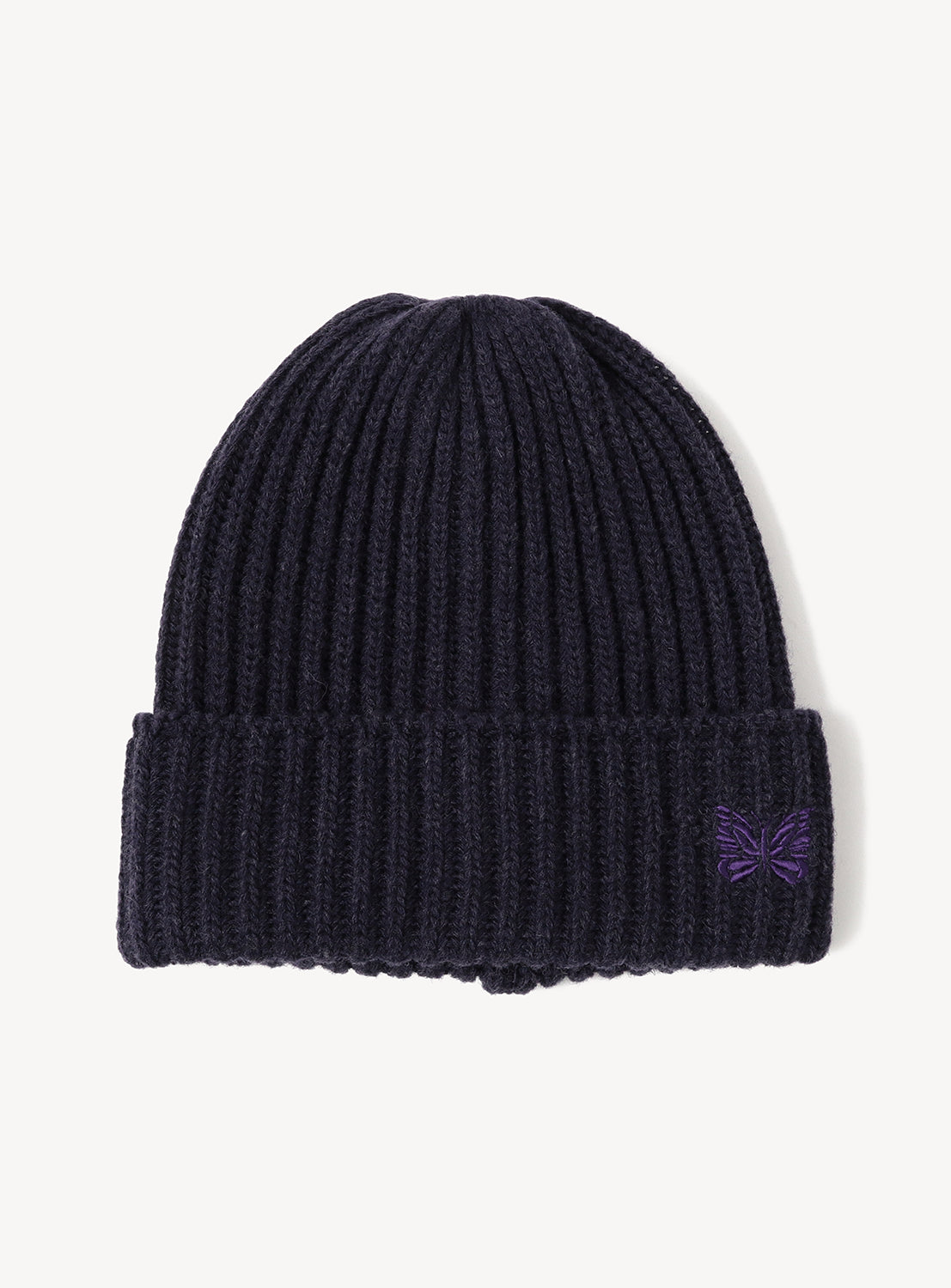 Dark navy NEEDLES Shetland Wool Watch Cap in a ribbed knit, featuring a small purple embroidered papillon on the cuff.