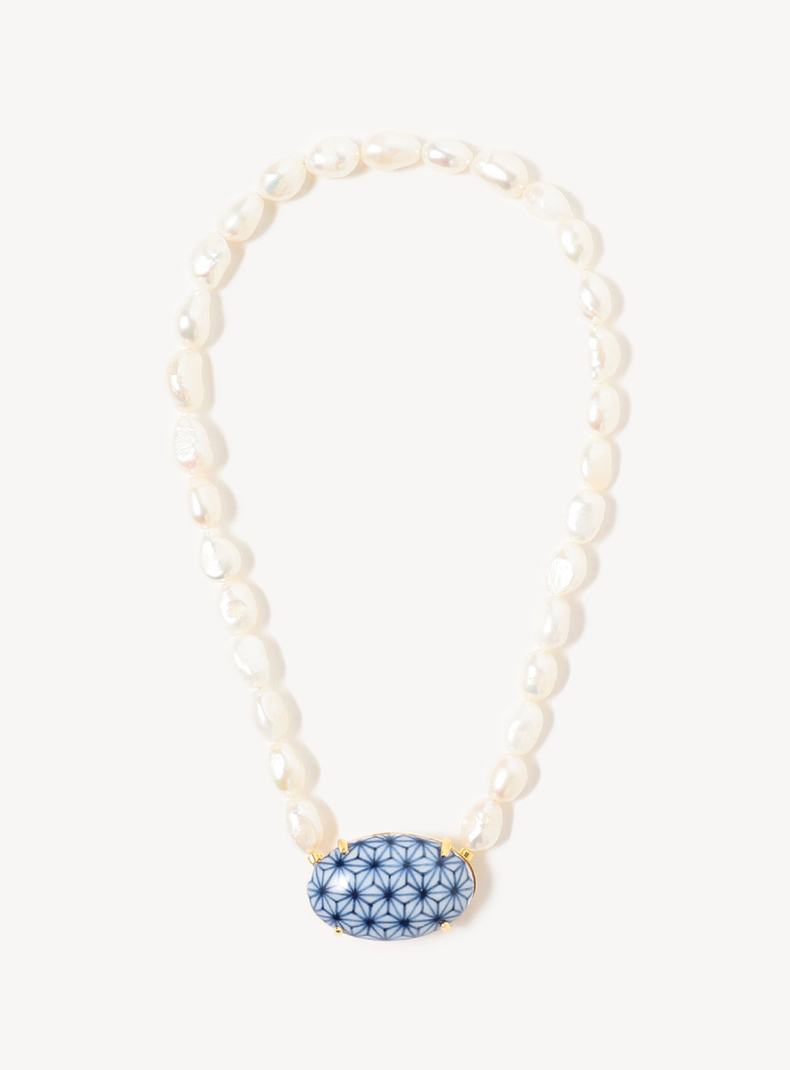 The Arita Ware Motif & Baroque Pearl Necklace - Small by Hizen Jewelry features irregular baroque freshwater pearls and a central blue oval pendant with a geometric floral design, inspired by traditional Japanese jewelry.