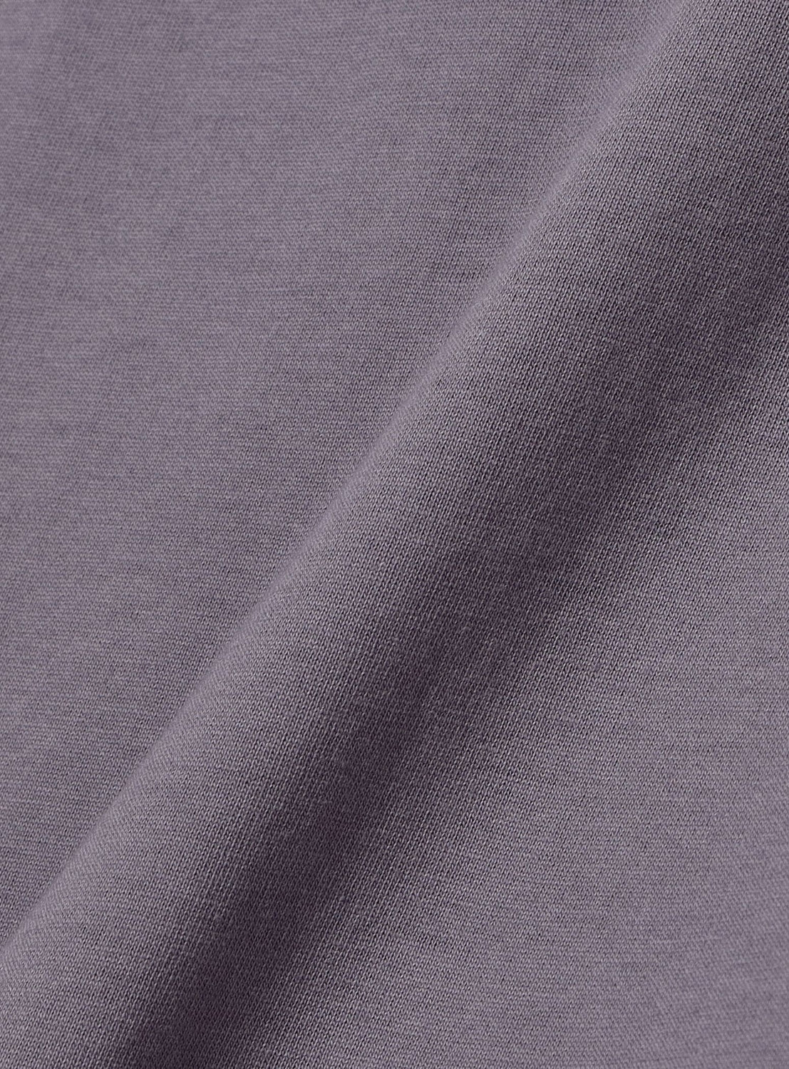 Close-up of BEAMS BOY's Two-Tone Vintage Raglan T-shirt in light purple, highlighting its soft texture, fine weave, and subtle diagonal fold—capturing the distinct vintage look of this classic piece.