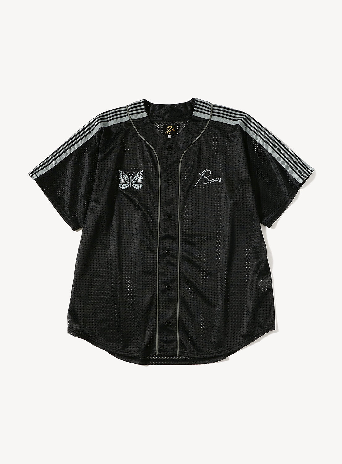 Experience streetwear-inspired style and comfort with the NEEDLES [Exclusive] Needles 50th Baseball Shirt, a black short-sleeve button-up jersey crafted from breathable mesh. This shirt features light gray shoulder stripes, a signature butterfly patch on the left chest, B script on the right chest, and delivers a nod to classic BEAMS x Needles baseball shirts.