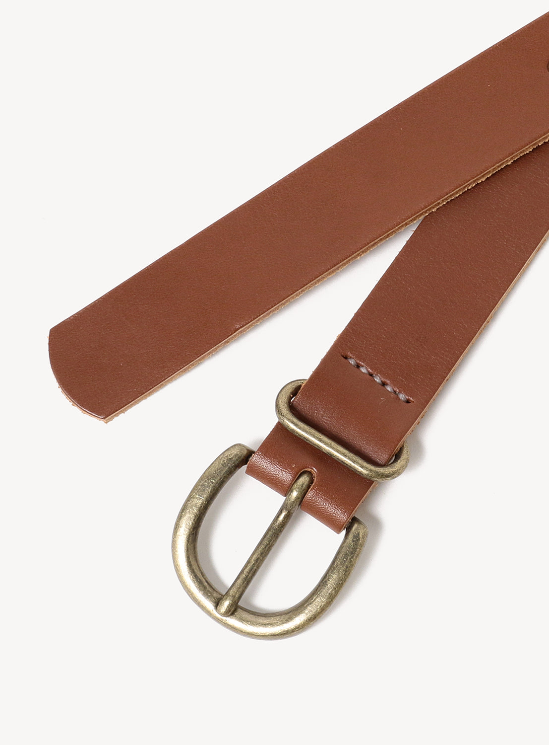 The Tanning Belt by Hender Scheme is a brown cow leather belt with durable construction and a gold-toned rounded metal buckle, displayed flat on a white background.