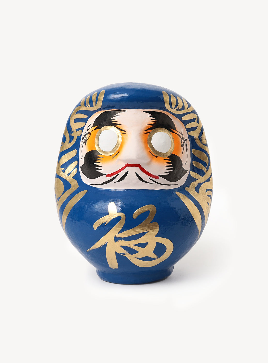 The [Exclusive] BEAMS JAPAN Small Shirakawa Daruma LA by BEAMS JAPAN, featuring a striking blue design with gold accents and blank white eyes that highlight traditional Japanese craftsmanship, is showcased against a plain white background.