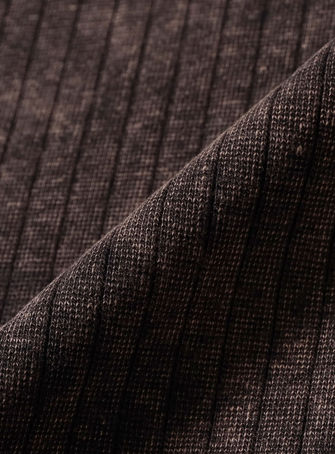 Close-up of a dark brown stretch pique rib fabric with a folded edge from the Vintage-Look Faded Stretch Rib T-Shirt by BEAMS.