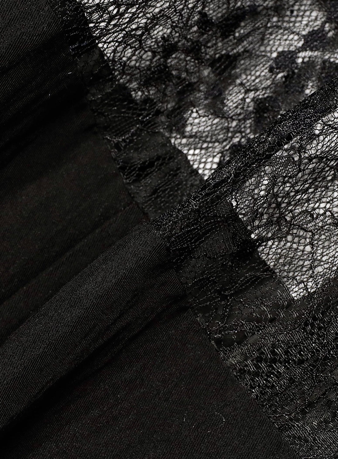 Close-up of the Lace Cut-Out Cami Dress by Ray BEAMS, highlighting the black lace fabric with an intricate floral pattern and sheer mesh accents—the fine stitching and contrasting textures between opaque and see-through panels showcase the delicate elegance that makes this dress perfect for a lingerie-inspired look.