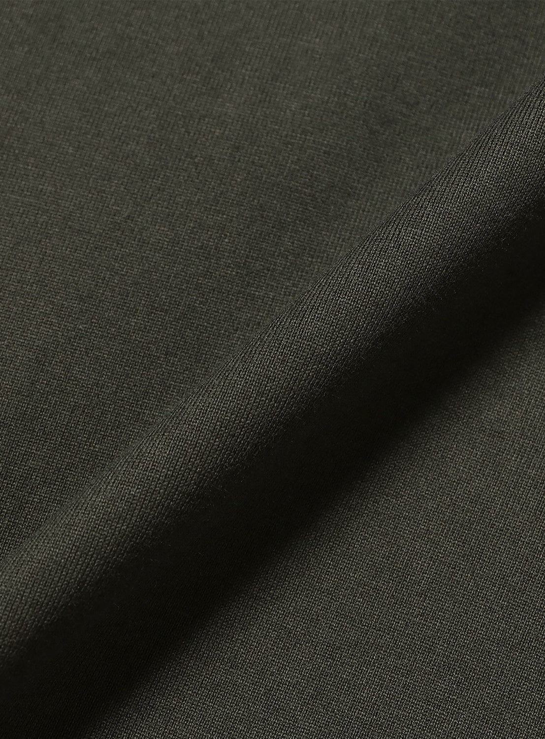 Close-up of dark olive green fabric with smooth texture and tight weave, featured in the Not A T-Shirt by COG THE BIGSMOKE—ideal for wide silhouettes, minimal design, and a sculptural hem.