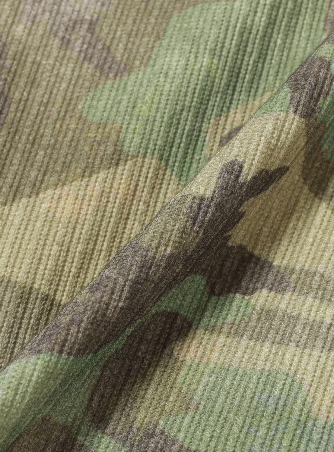 Close-up of a BEAMS Henley Neck Long-Sleeve T-shirt in a ribbed, green and brown camouflage pattern with a buttoned neckline.