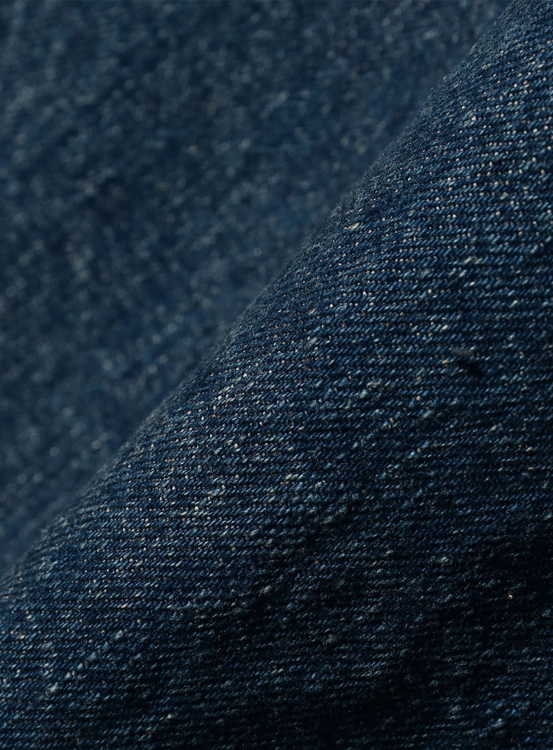 Close-up of dark blue denim fabric texture