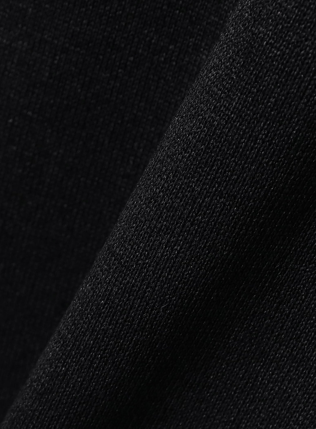 Close-up of the crepuscule [Exclusive] Washi Knit T-Shirt in black, highlighting its breathable fine knit texture and intricate weave under soft lighting.