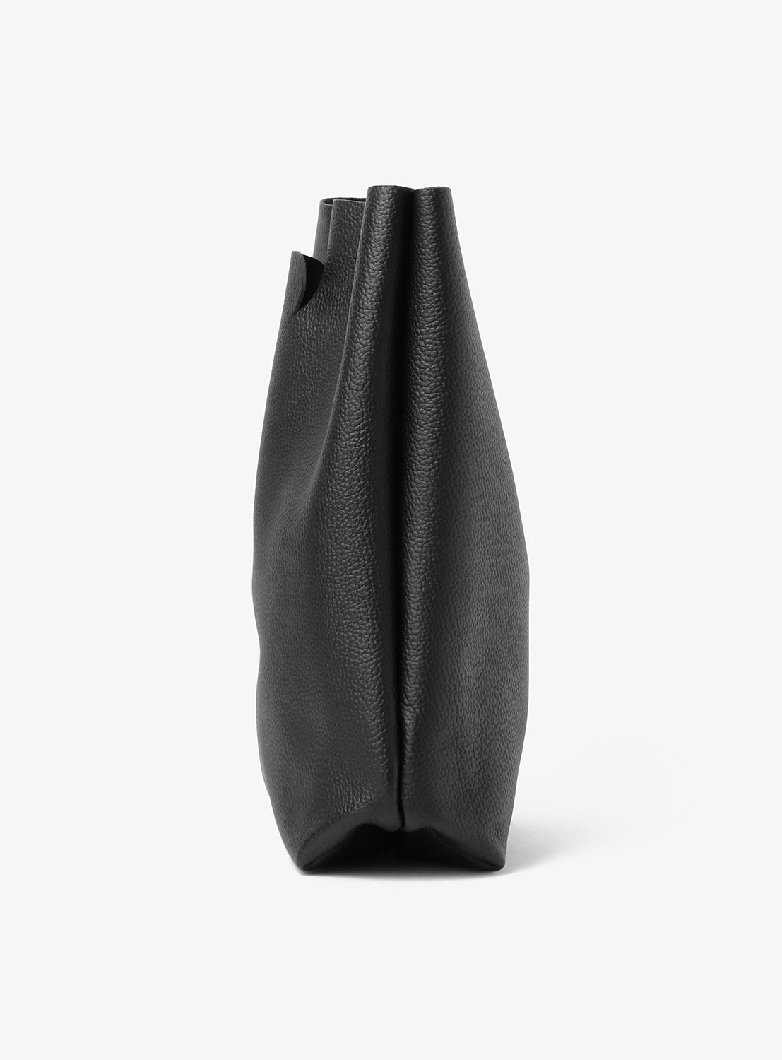 Side view of a Hender Scheme Not Eco Big Bag, a minimalist, black pebbled leather tote.