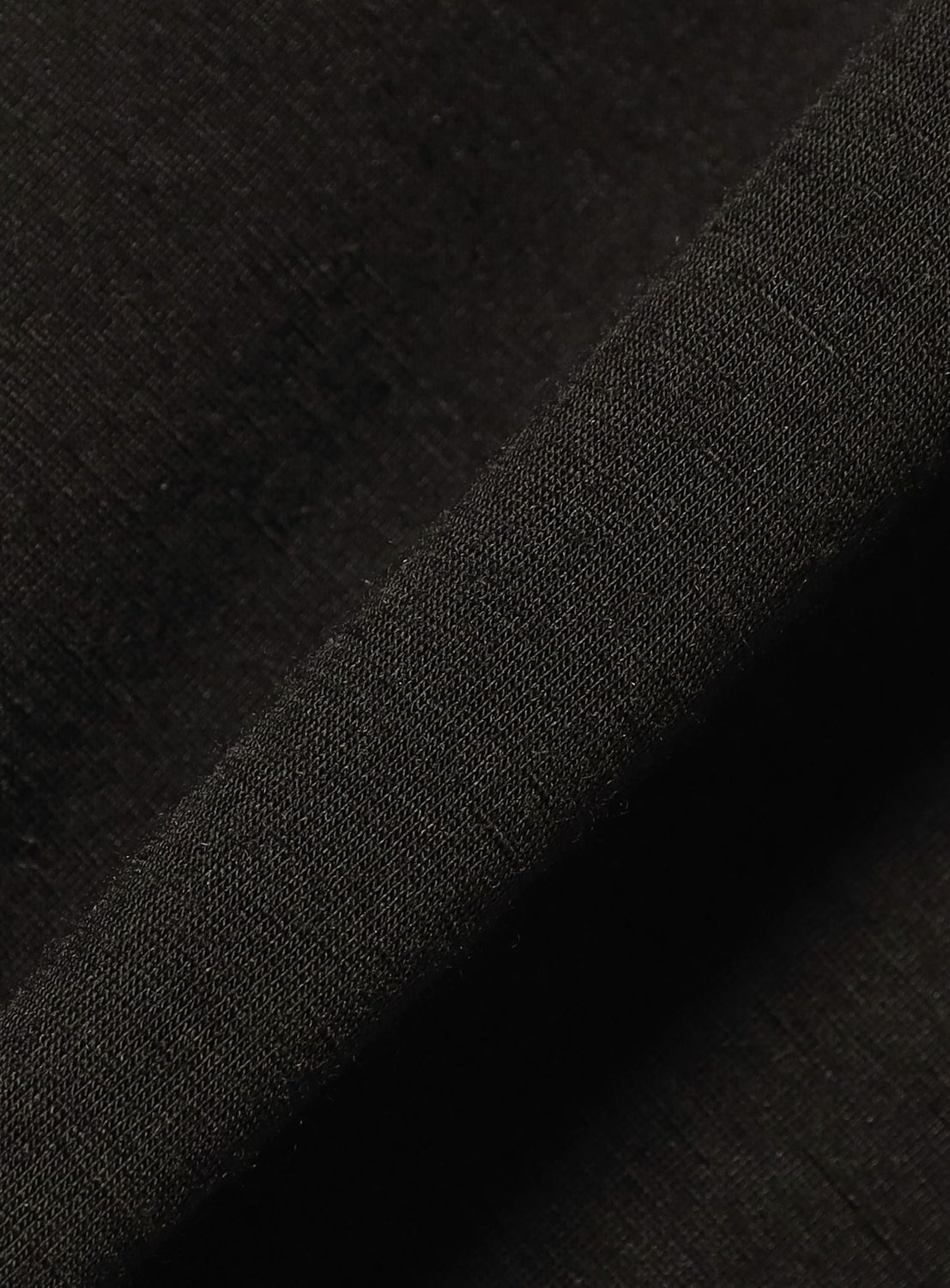 Close-up of black textured fabric with a diagonal stripe