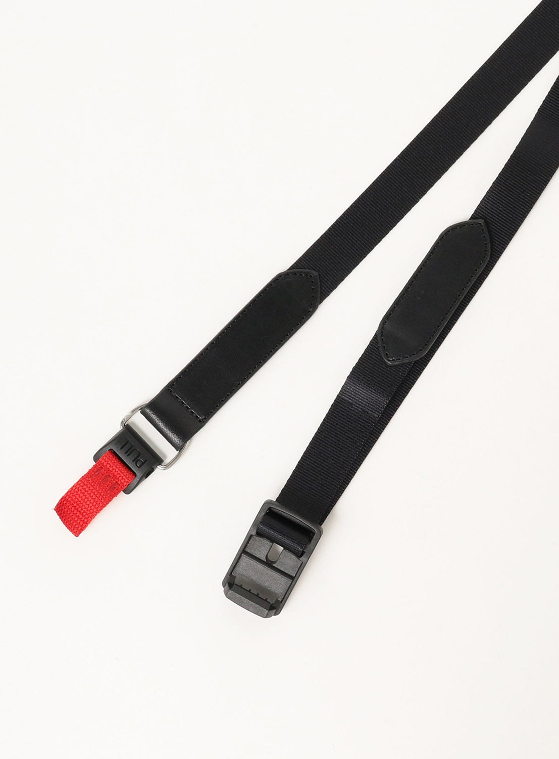 Two Hender Scheme Fidlock Nylon Belts are displayed on a white surface: one with a FIDLOCK magnetic buckle and red pull tab, the other with a padded section. Both black belts are expertly crafted in Japan.
