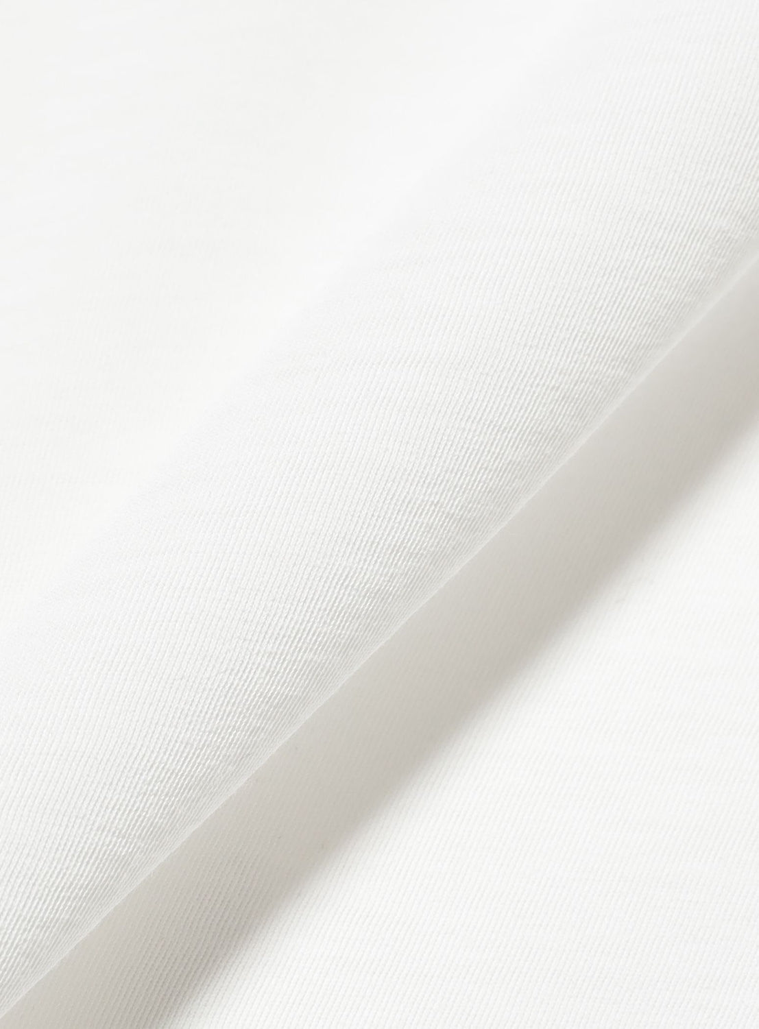 Close-up of a folded Relaxed Fit Heat Protection T-Shirt by BEAMS in white, showing a subtle diagonal weave pattern and smooth texture.