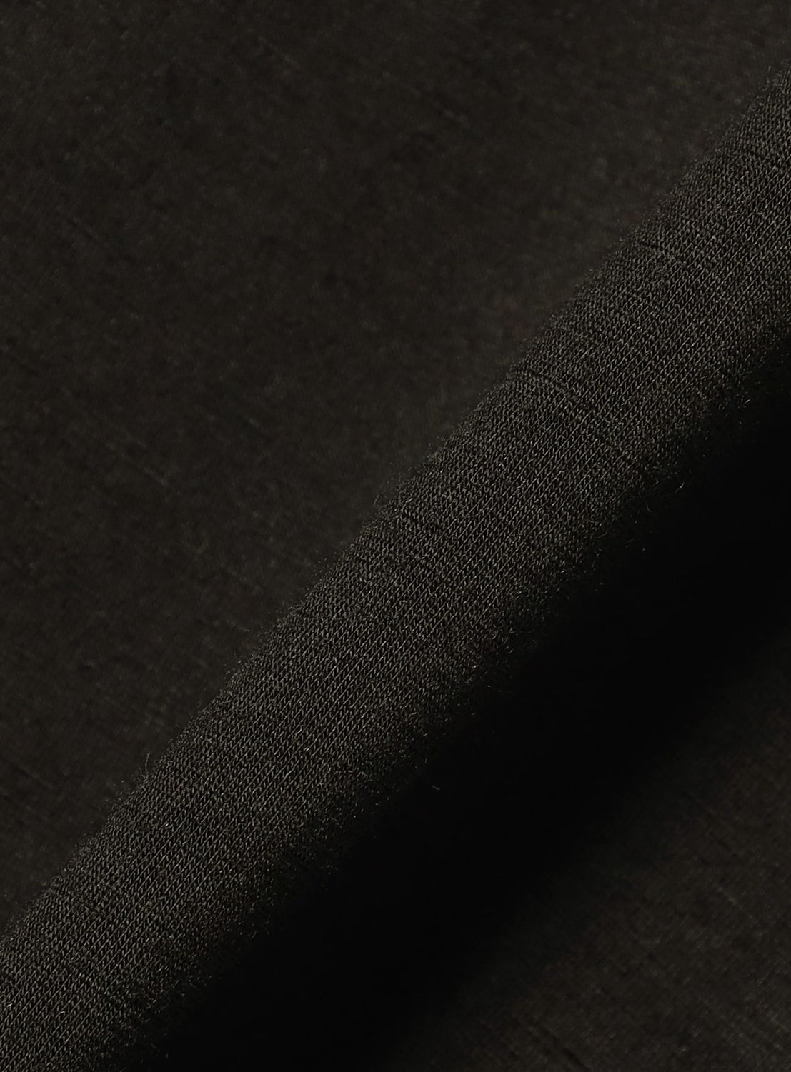 Close-up of the A - Washable Merino Wool Sleeveless Top by BEAMS in dark brown, showing a diagonal seam that highlights the fabric’s texture, weave, and minimalist construction.