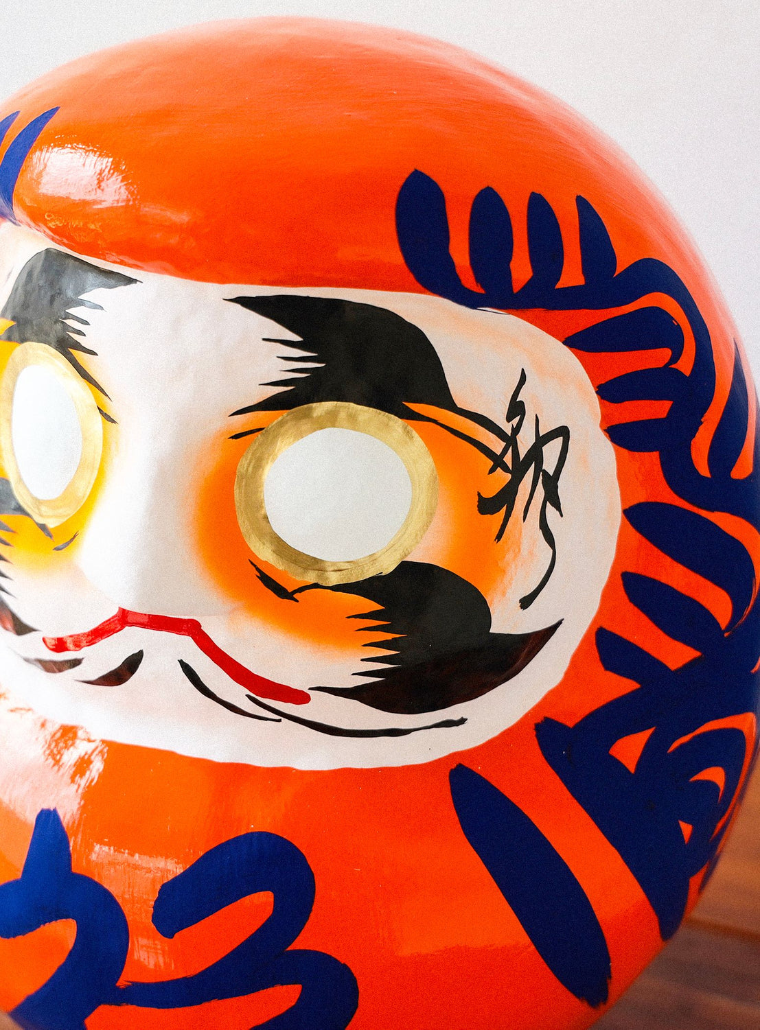 Decorative object with a face design on an orange background
