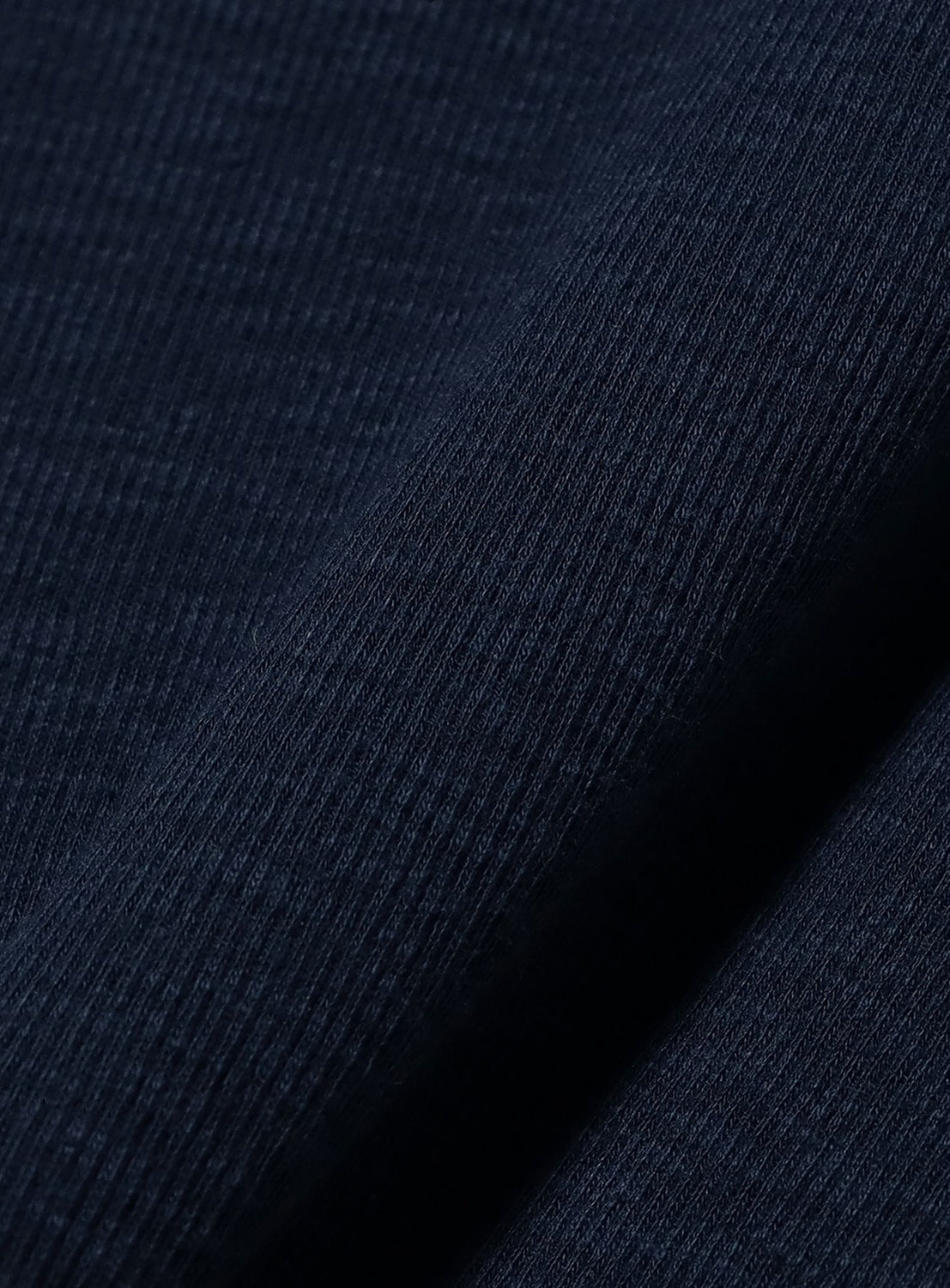 Close-up of the BEAMS BOY Layered Rib Tank Top in dark navy blue, highlighting its fine vertical ribbed knit texture and soft, textured surface with gentle diagonal folds.