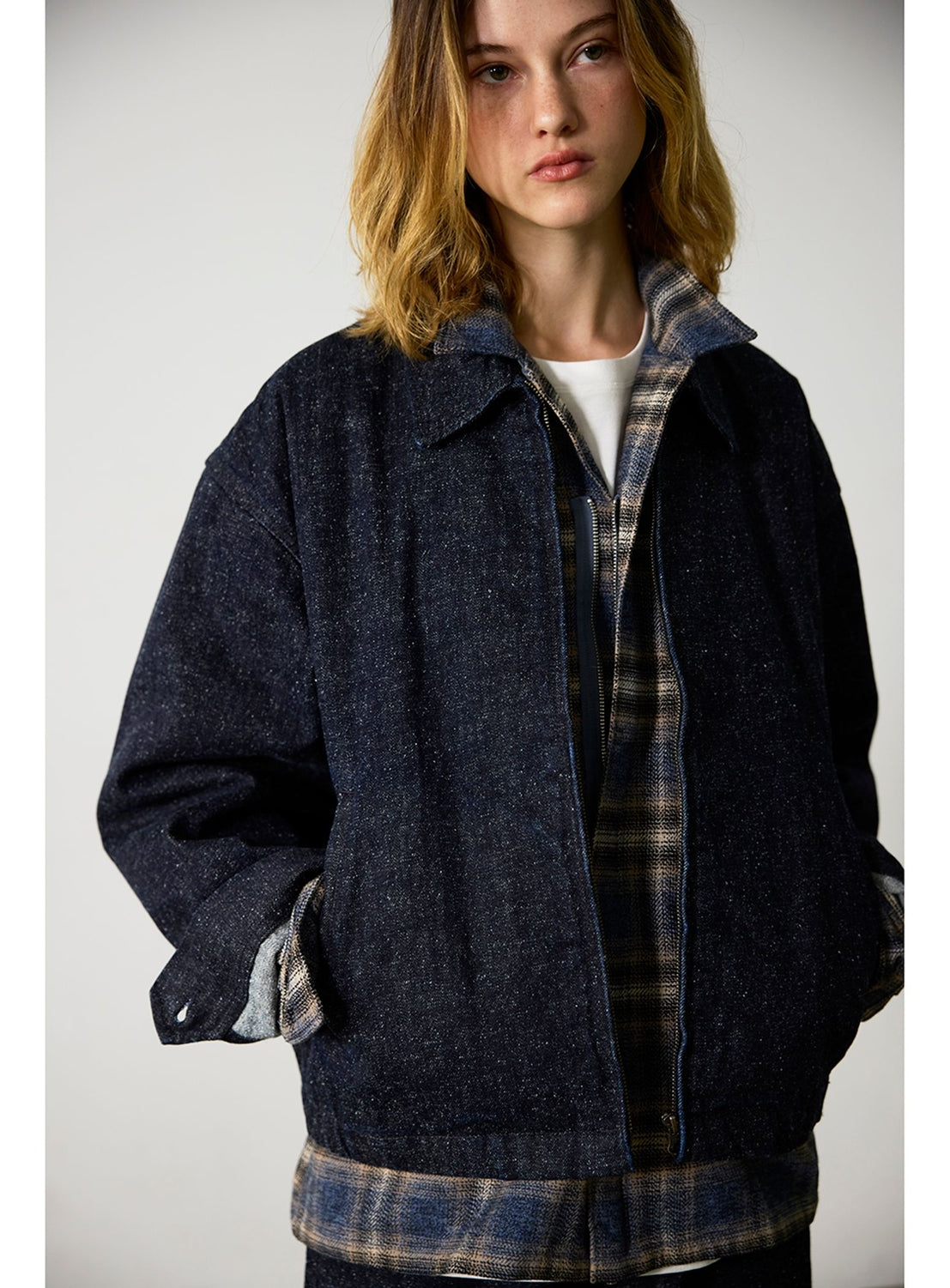BEAMS Nep Denim Zip Jacket in dark blue, styled in a wide-fit silhouette over a brown and blue plaid collared shirt.
