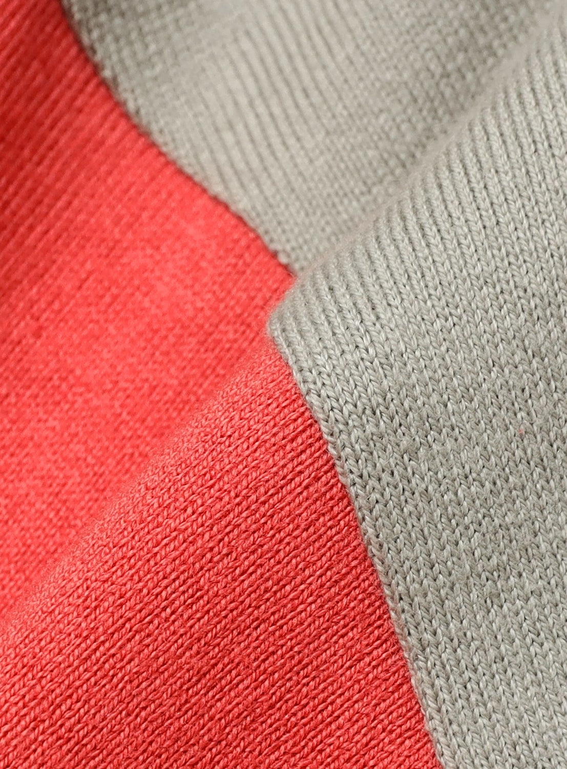 Close-up of a wide fit Baseball 9/10 Sleeve T-Shirt by BEAMS with large red and gray color-blocked sections.