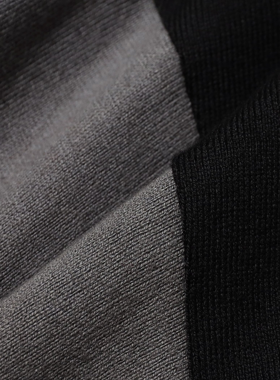 Close-up of the gray and black knit fabric of a BEAMS Baseball 9/10 Sleeve T-Shirt.