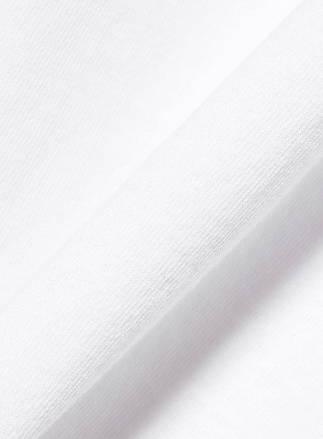 A close-up view of a folded section of the Esteban Jefferson ‘Brooklyn Banks’ Graphic T-Shirt by BEAMS T, highlighting the soft texture and weave pattern of its heavyweight cotton fabric.
