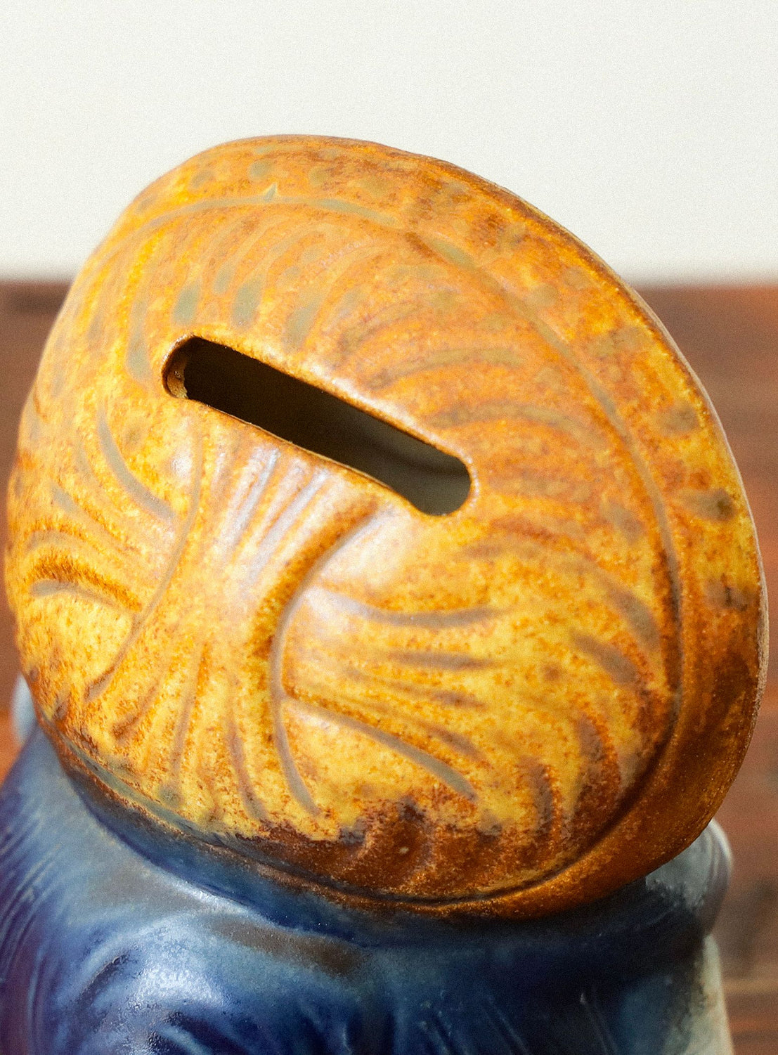 Rust-colored decorative object on a blurred background