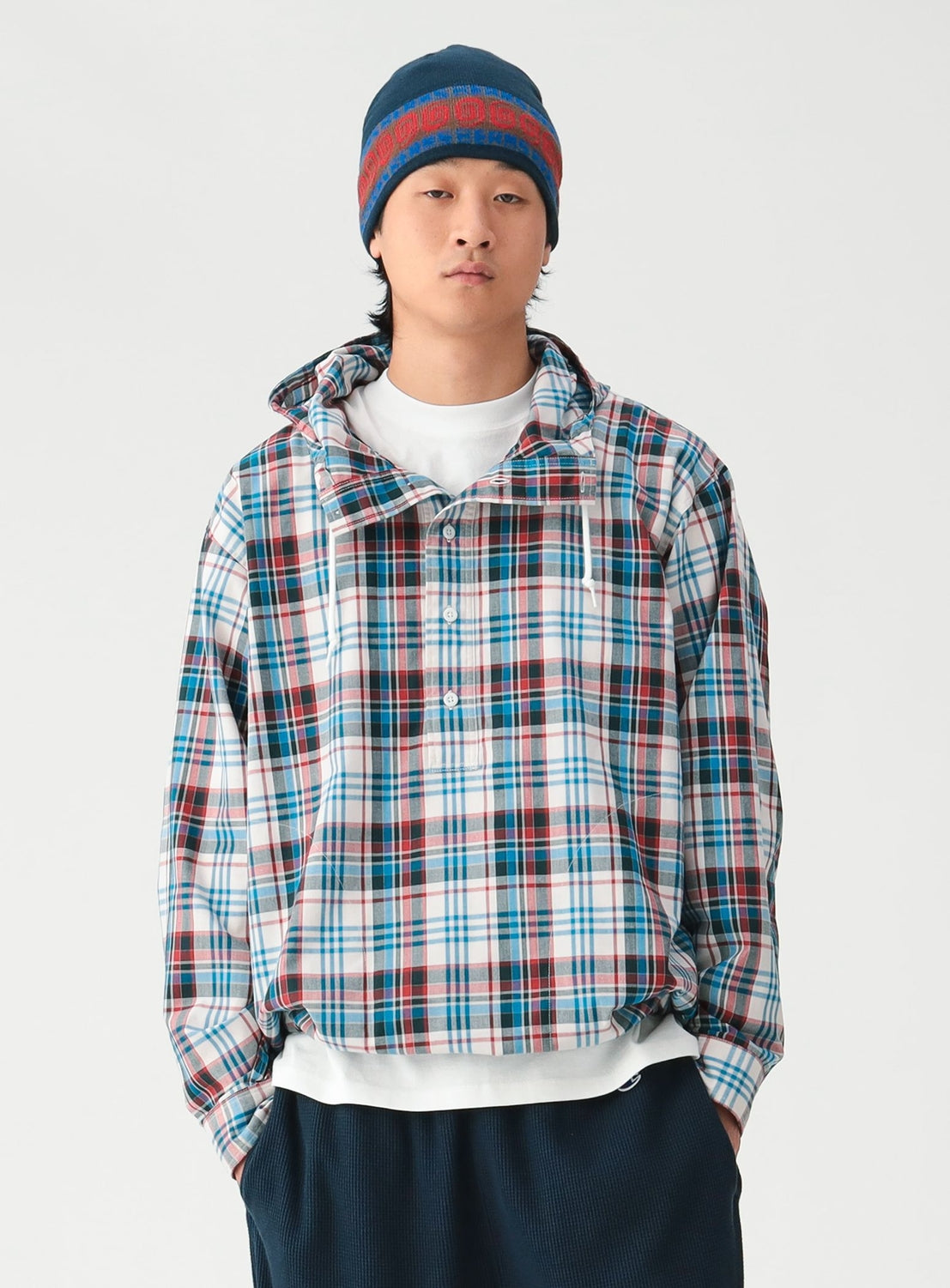 A person wearing a BEAMS Check Hooded Shirt over a white t-shirt and a knit beanie.