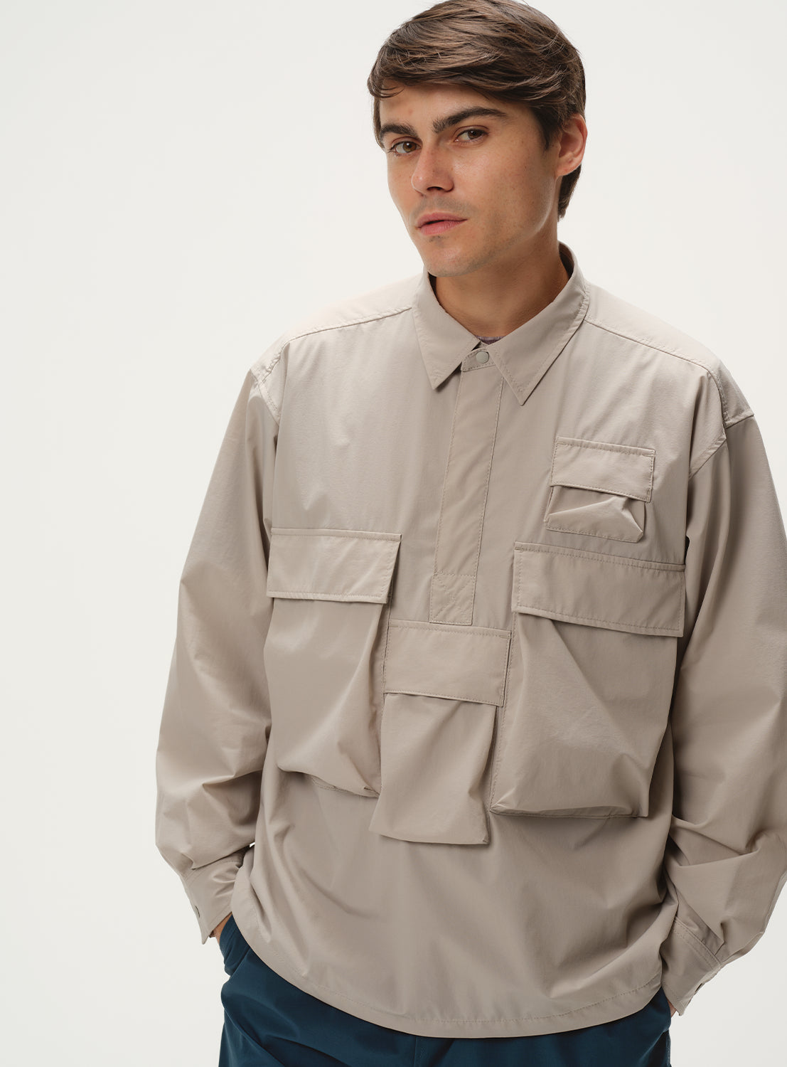 Full body shot of a model wearing a light grey shirt jacket.