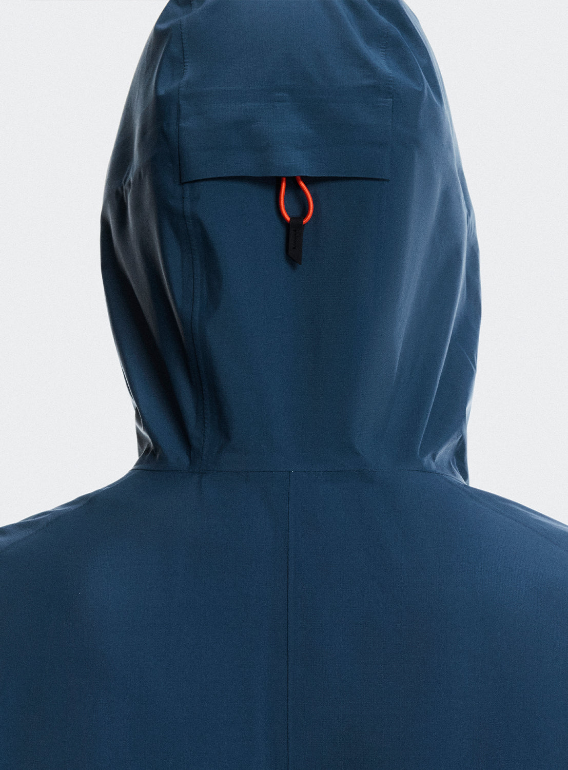 Back of the hood of the blue jacket highlighting a back loop. 